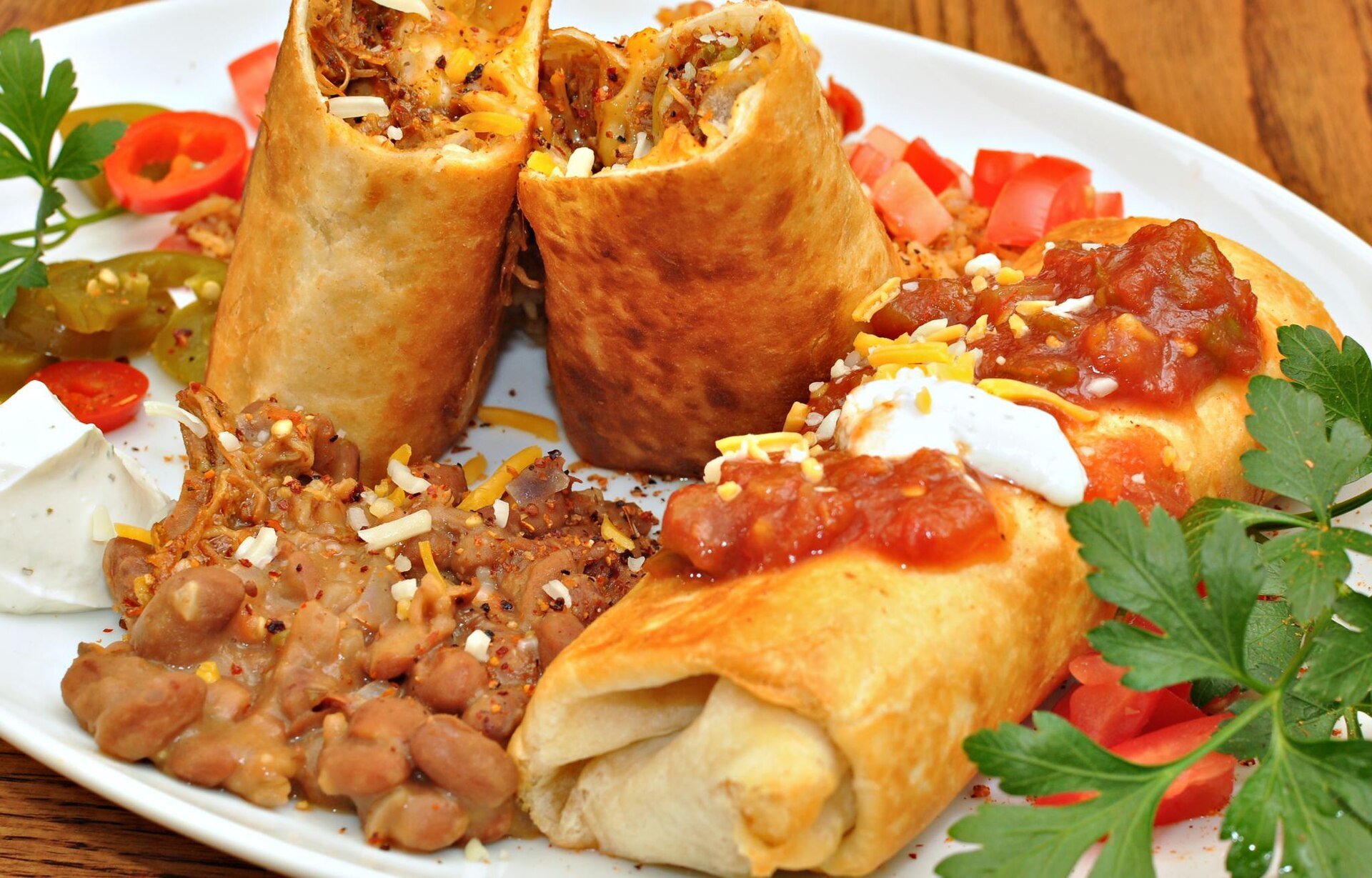 Golden fried chimichangas with beans and salsa