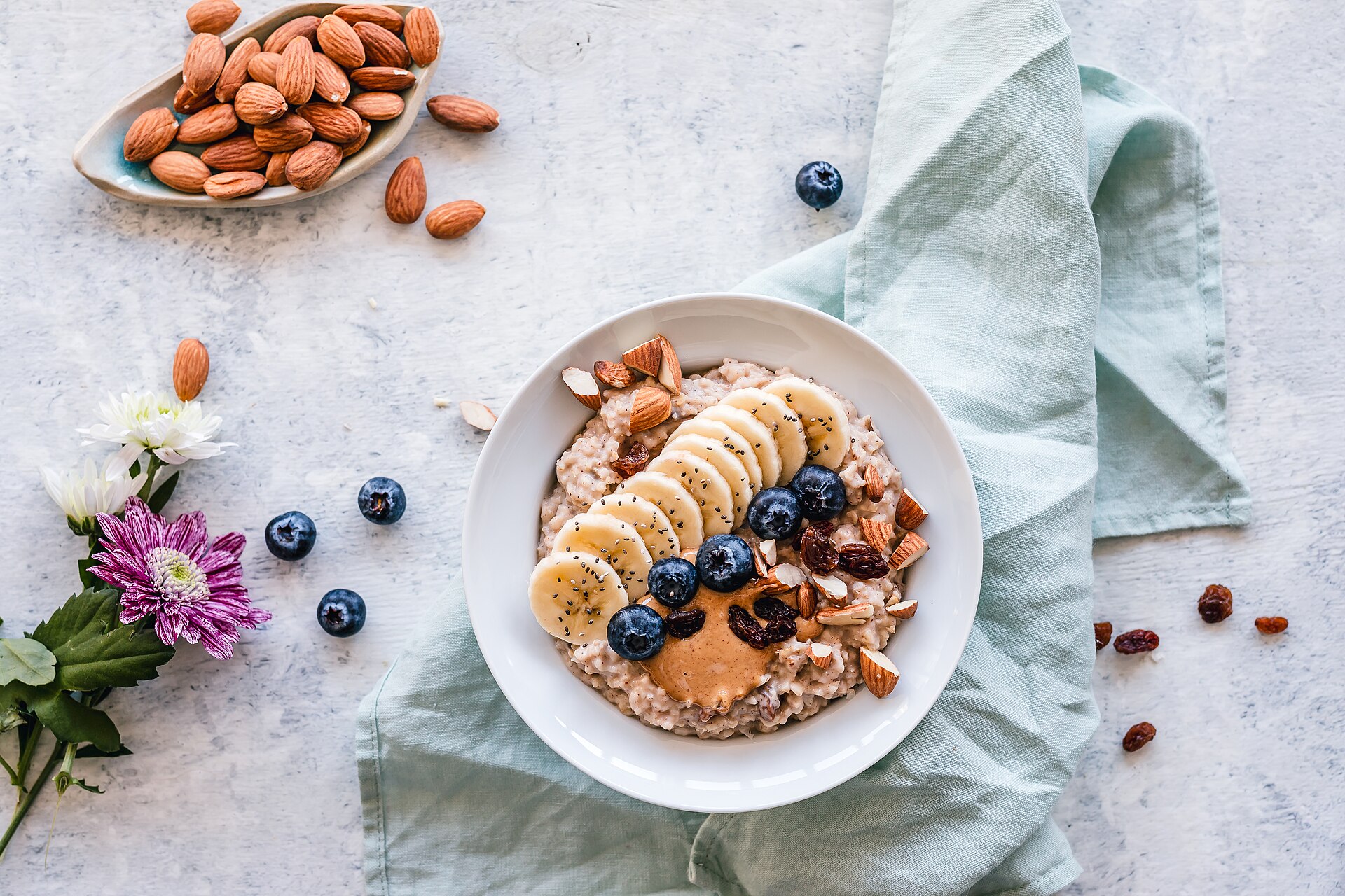 A bowl of oatmeal topped with banana, berries and nuts for an easy homemade breakfast