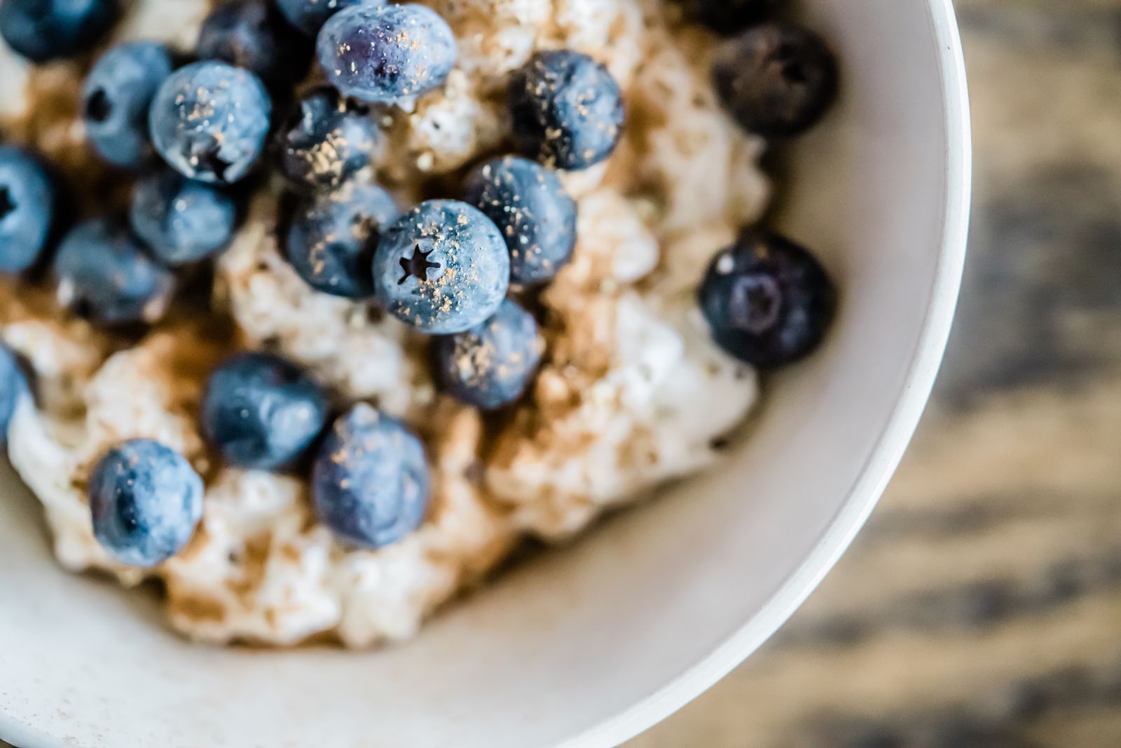 A bowl of oatmeal topped with fresh blueberries
