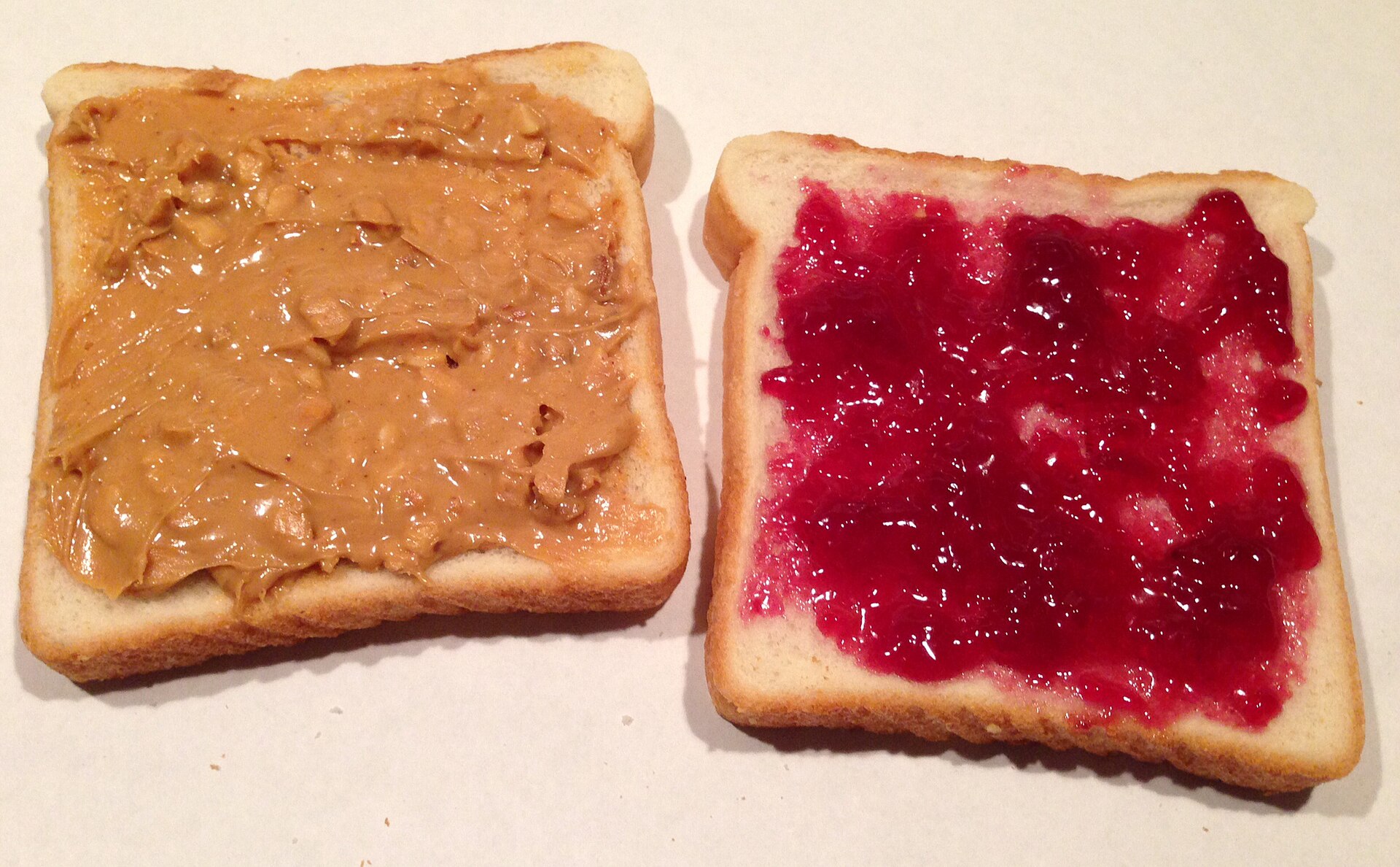 An open peanut butter and jelly sandwich on white bread, one of the ultraprocessed foods in the study meal