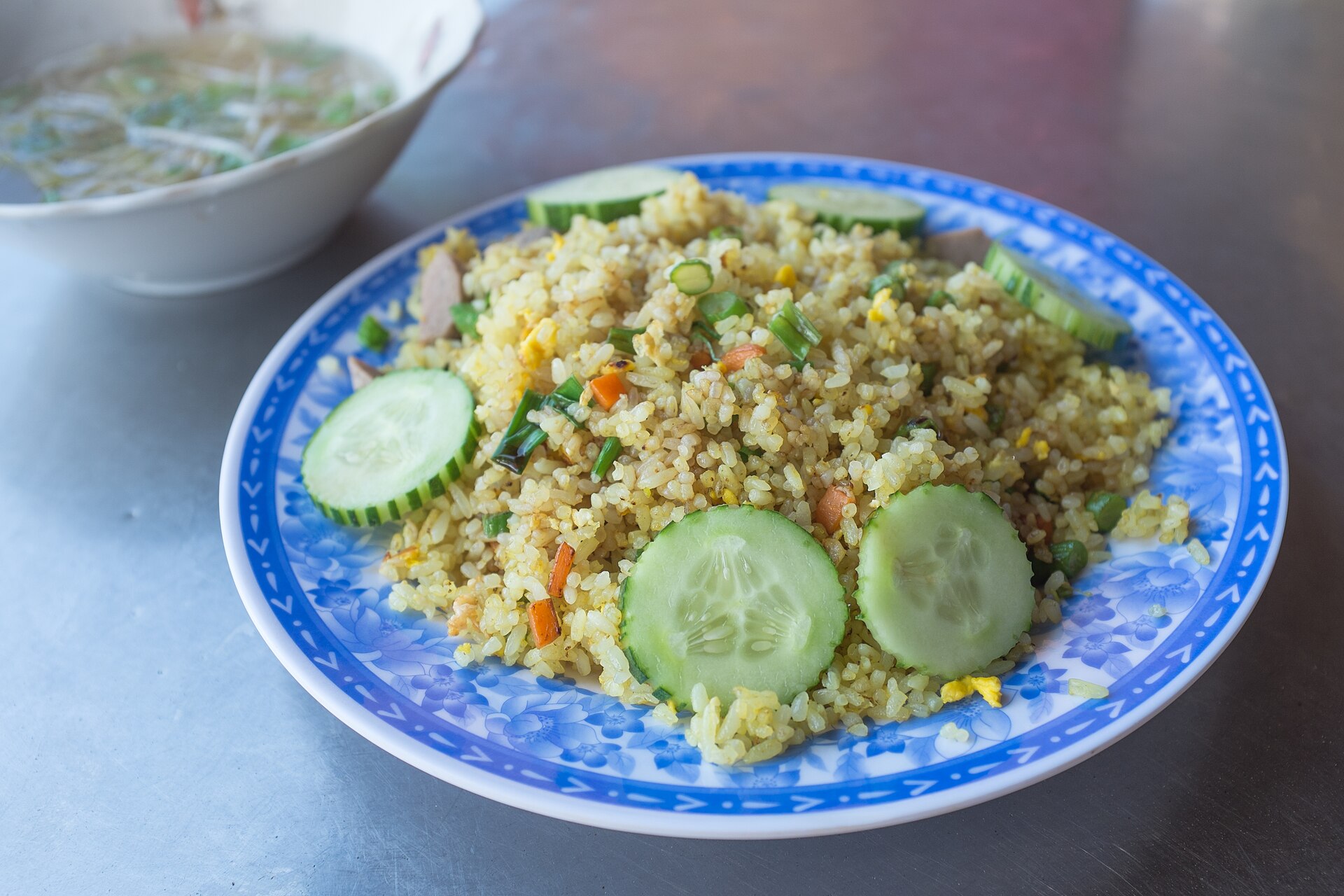 Vegetable and egg fried rice on a blue plate