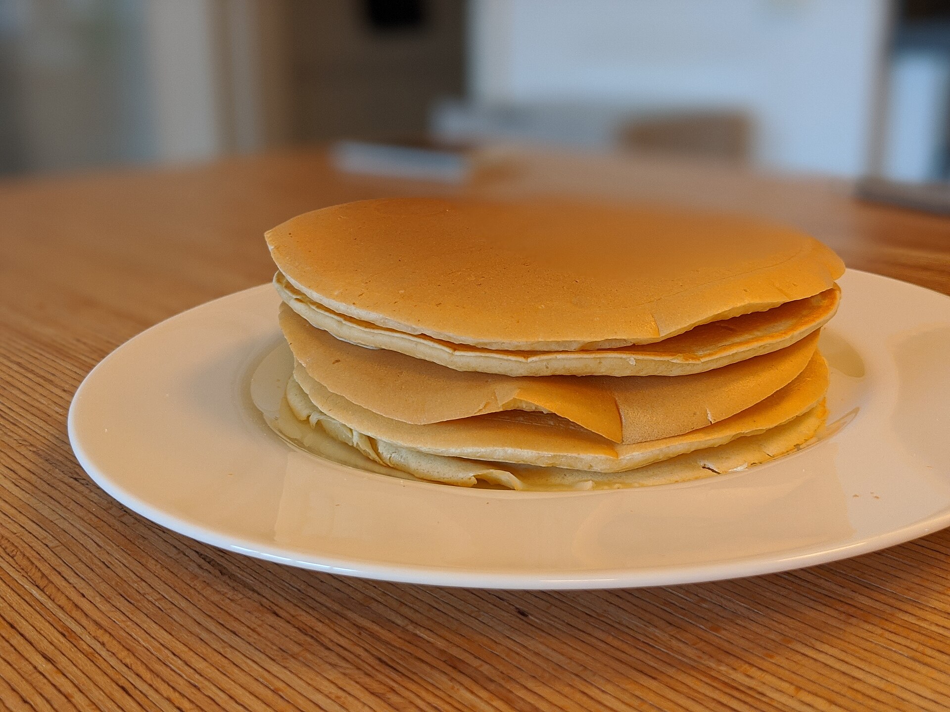 A tall stack of fluffy pancakes on a plate