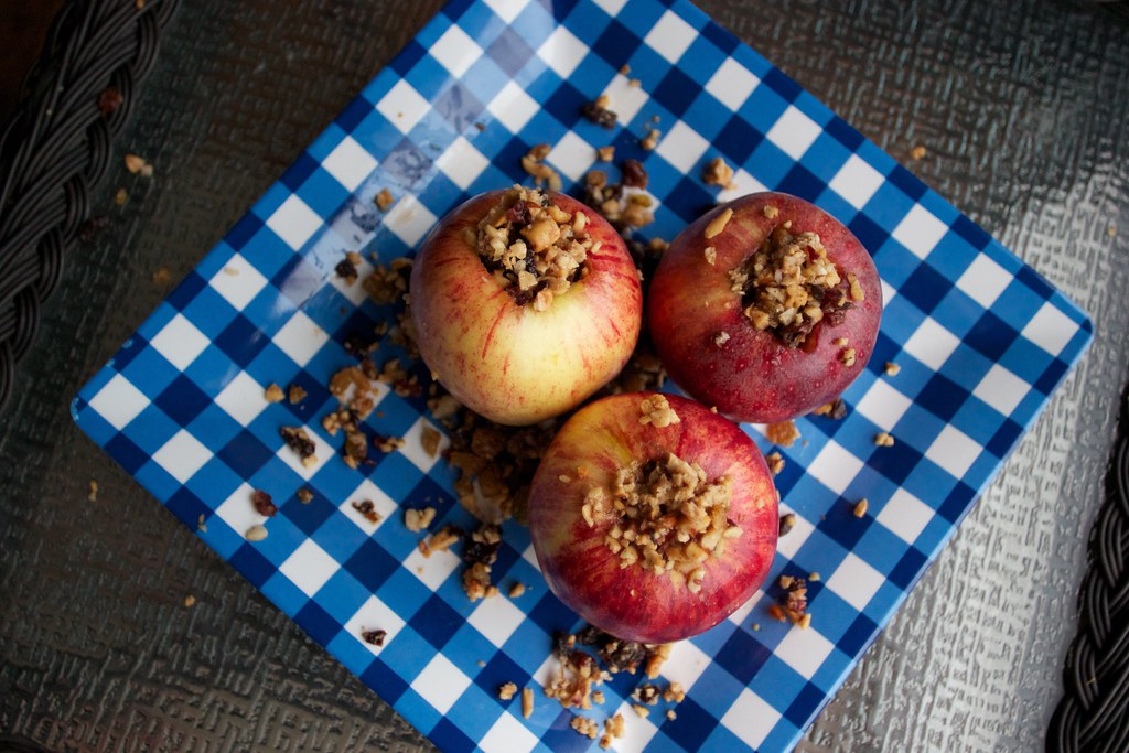 Old fashioned stuffed baked apples with oat filling on a checked cloth