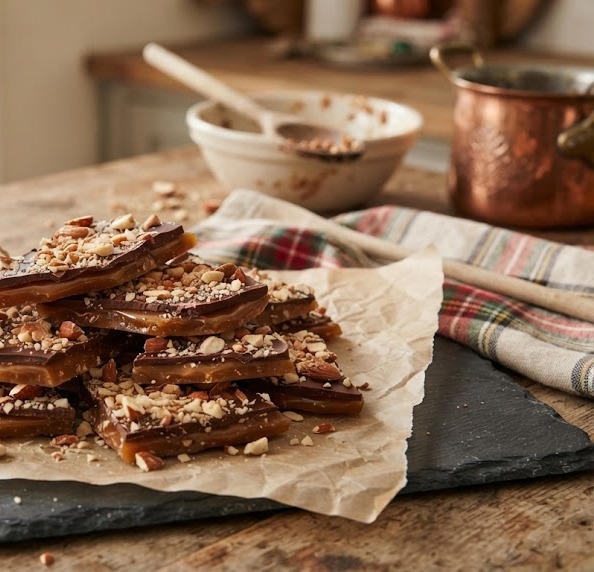 Chocolate almond toffee pieces on parchment