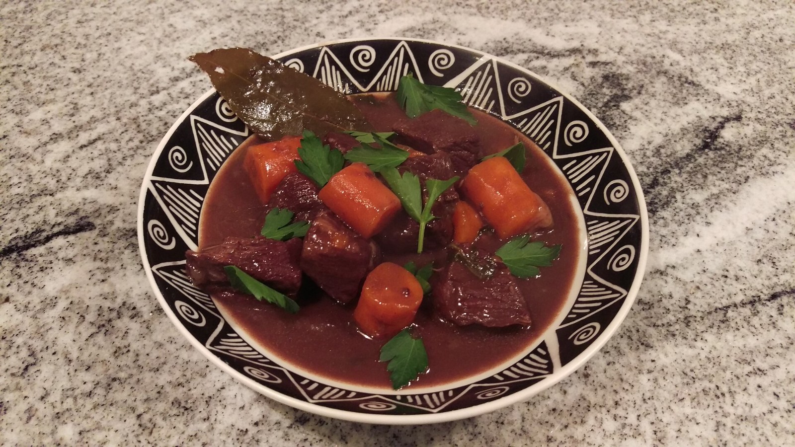 Boeuf bourguignon beef stew with carrots in a patterned bowl