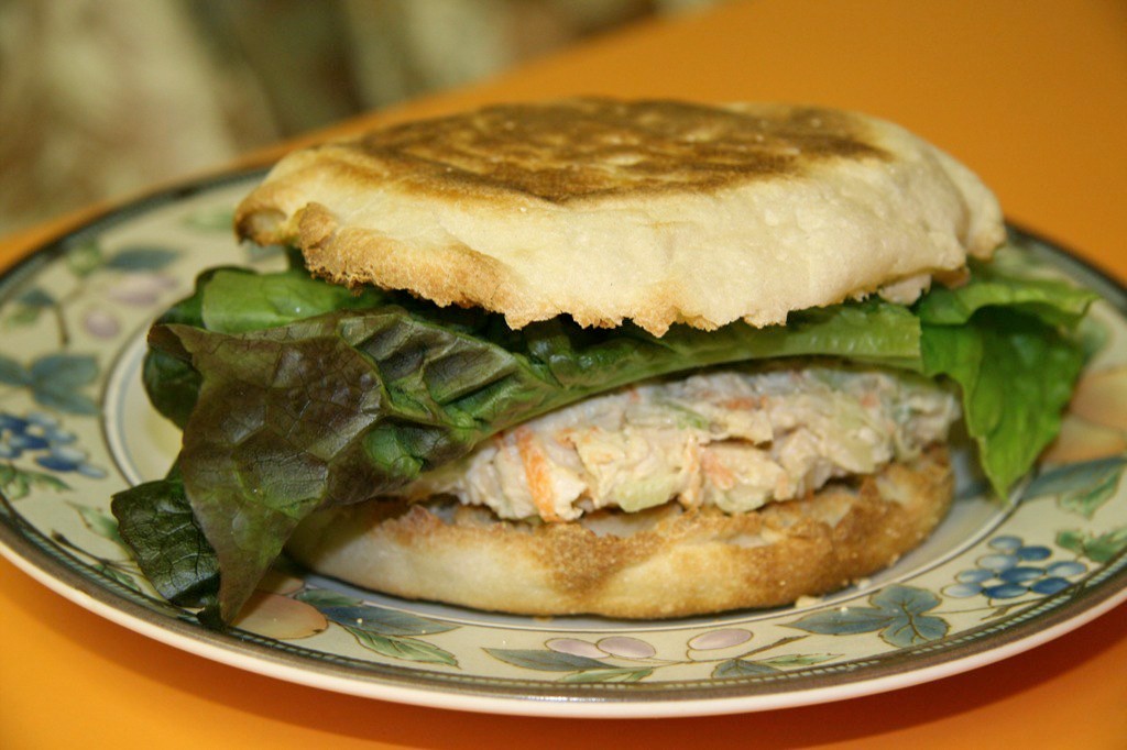 Chicken salad sandwich cut in half on a plate