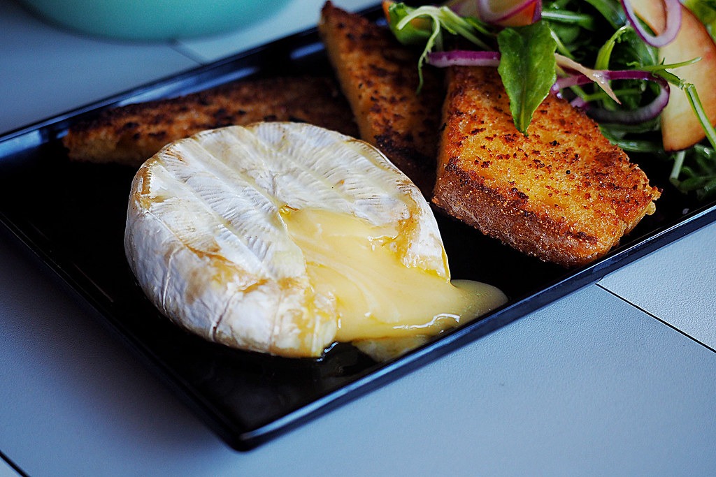 Air fryer baked brie wedge with melted center and toast