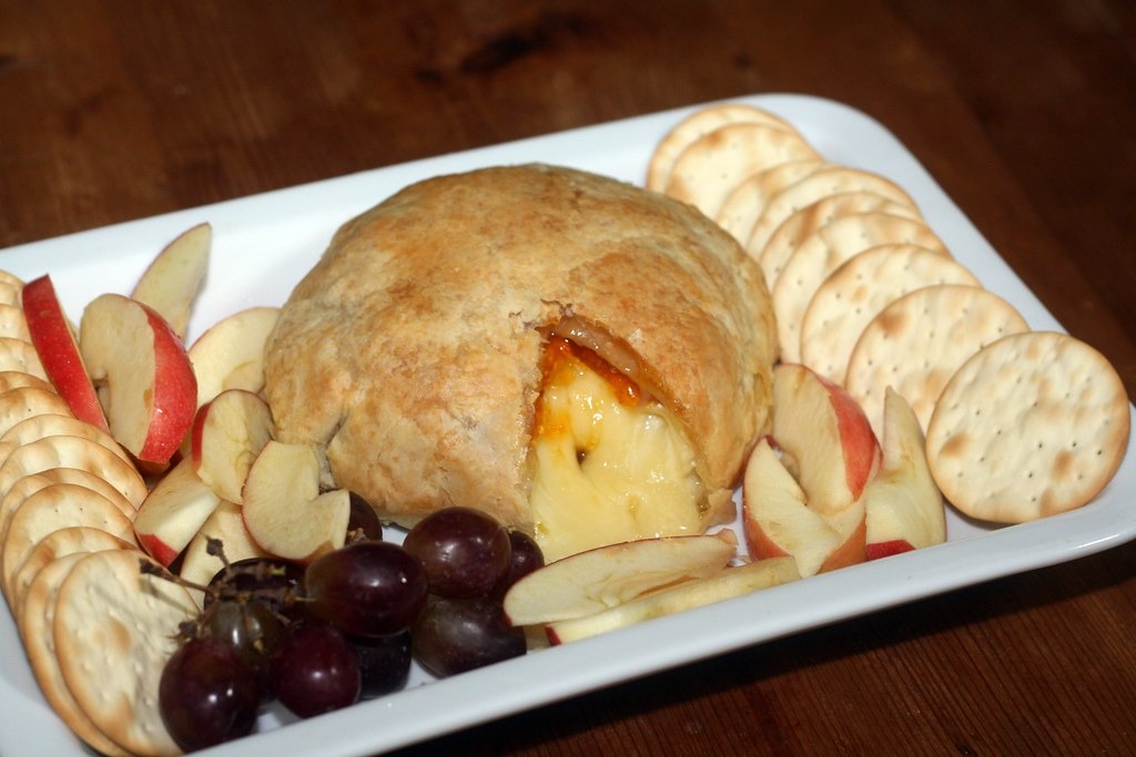 Apricot baked brie with apples, grapes and crackers