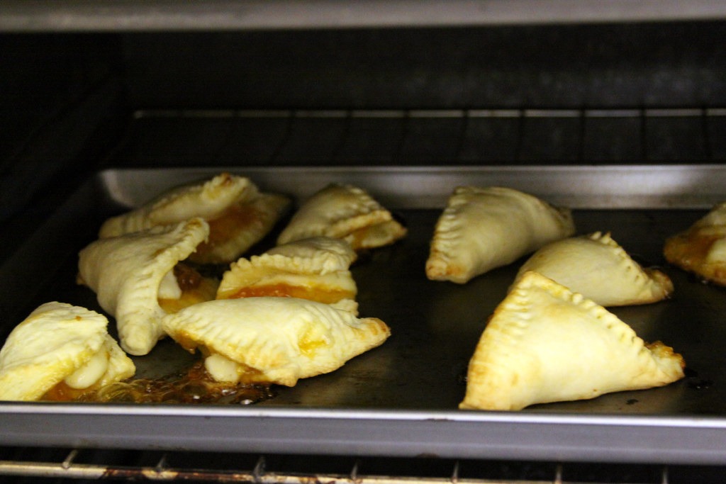 Golden apricot brie pastry bites on a baking tray