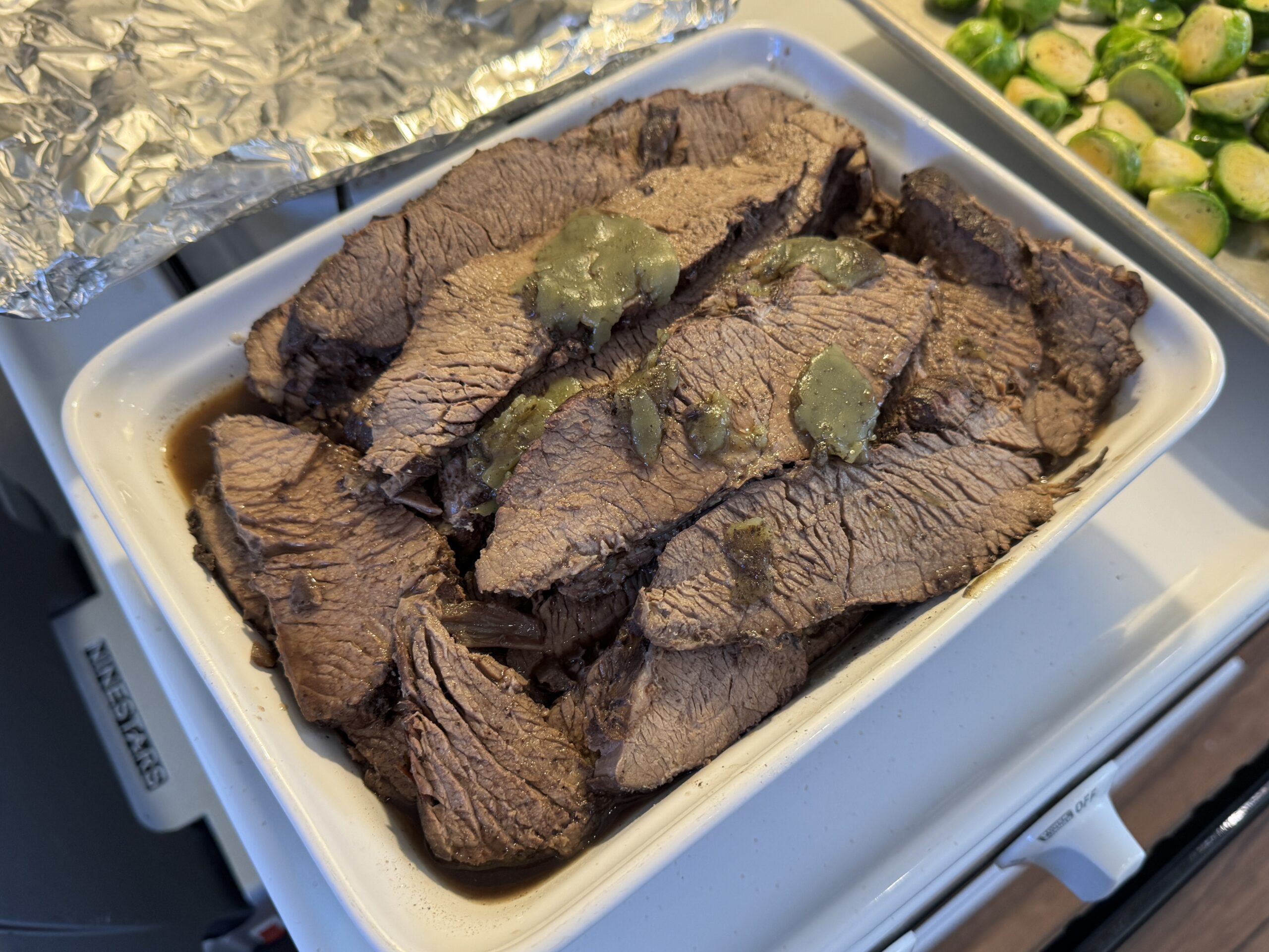 Cooked brisket in a pan ready for reheating