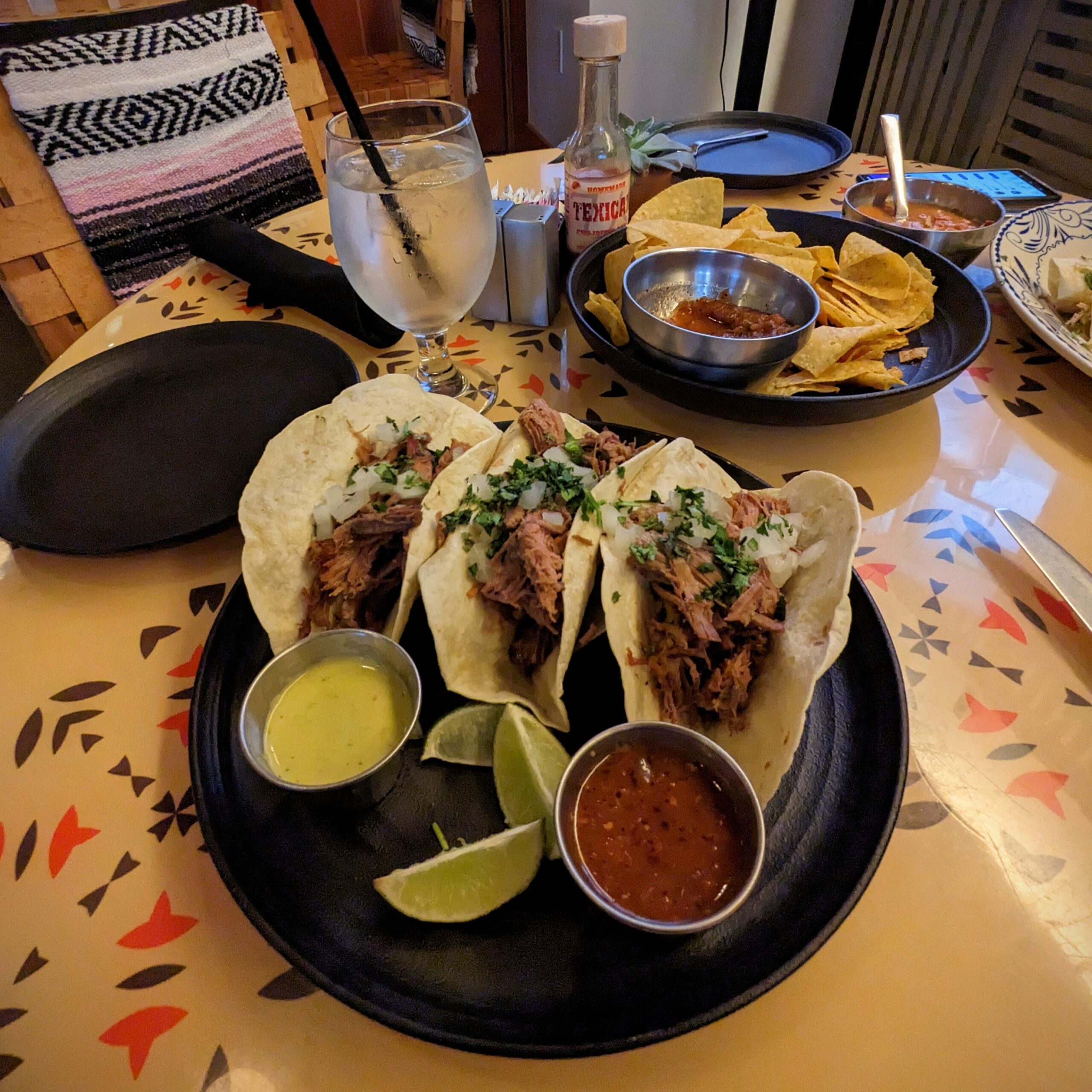 Shredded beef tacos with salsa and lime