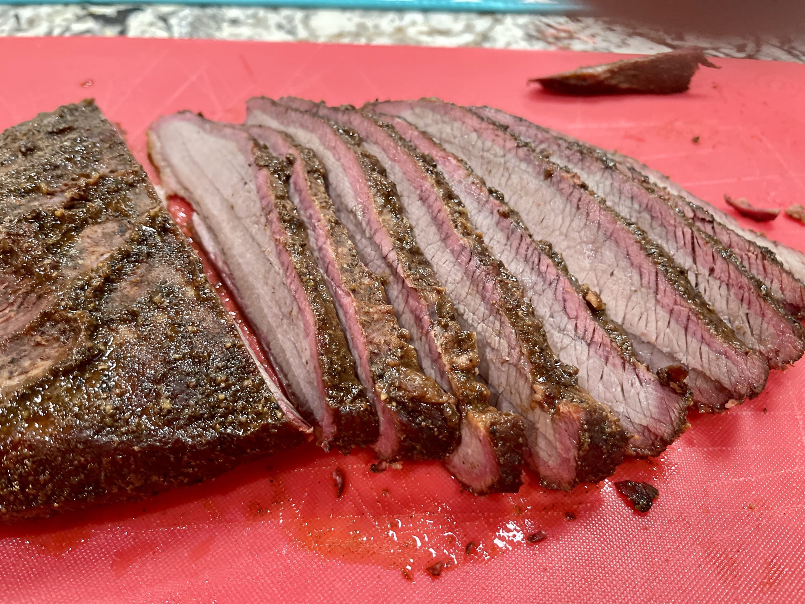 Sliced brisket showing the grain on a cutting board