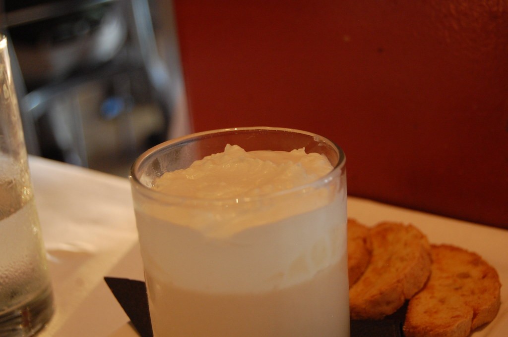 Homemade butterscotch pudding in a glass with whipped cream