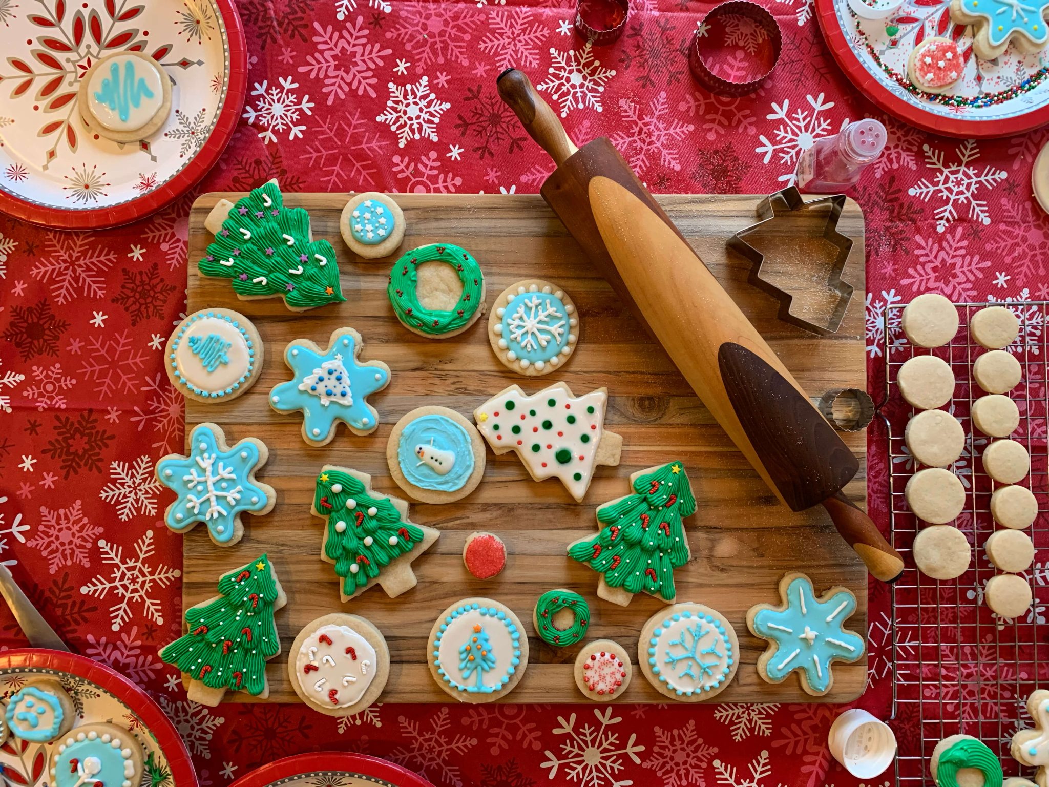 Christmas cutouts shaped like trees and snowflakes with icing and sprinkles