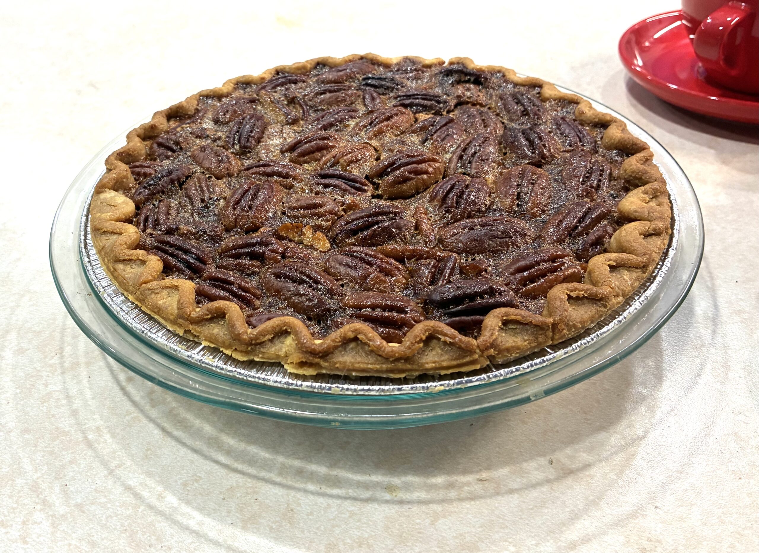 Whole Southern pecan pie in a glass dish