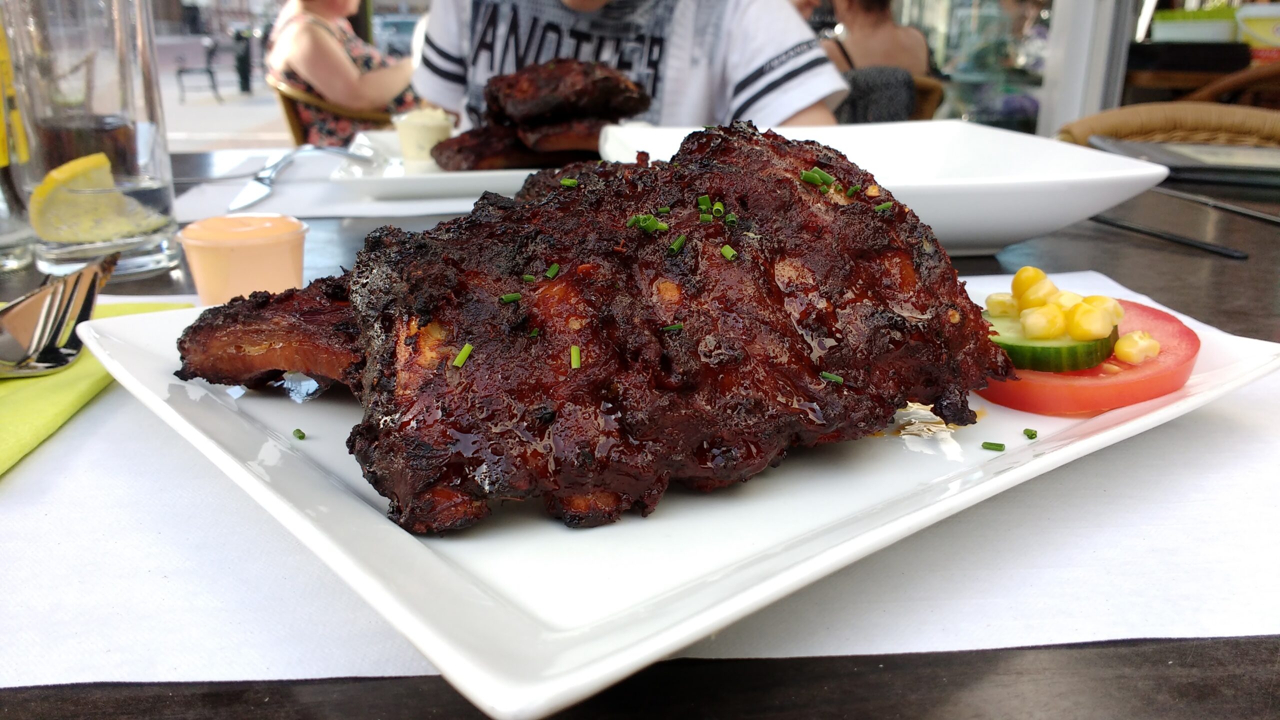 Glazed barbecue ribs on a white plate