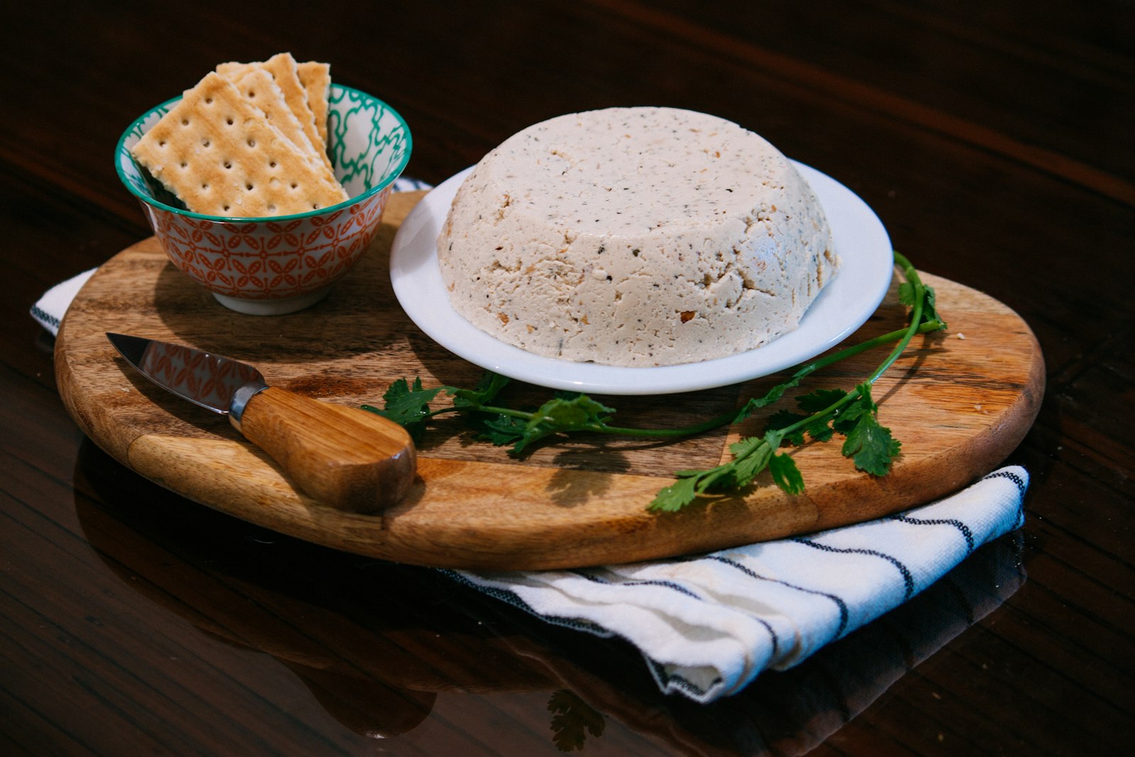 Smooth garlic herb cheese ball with crackers