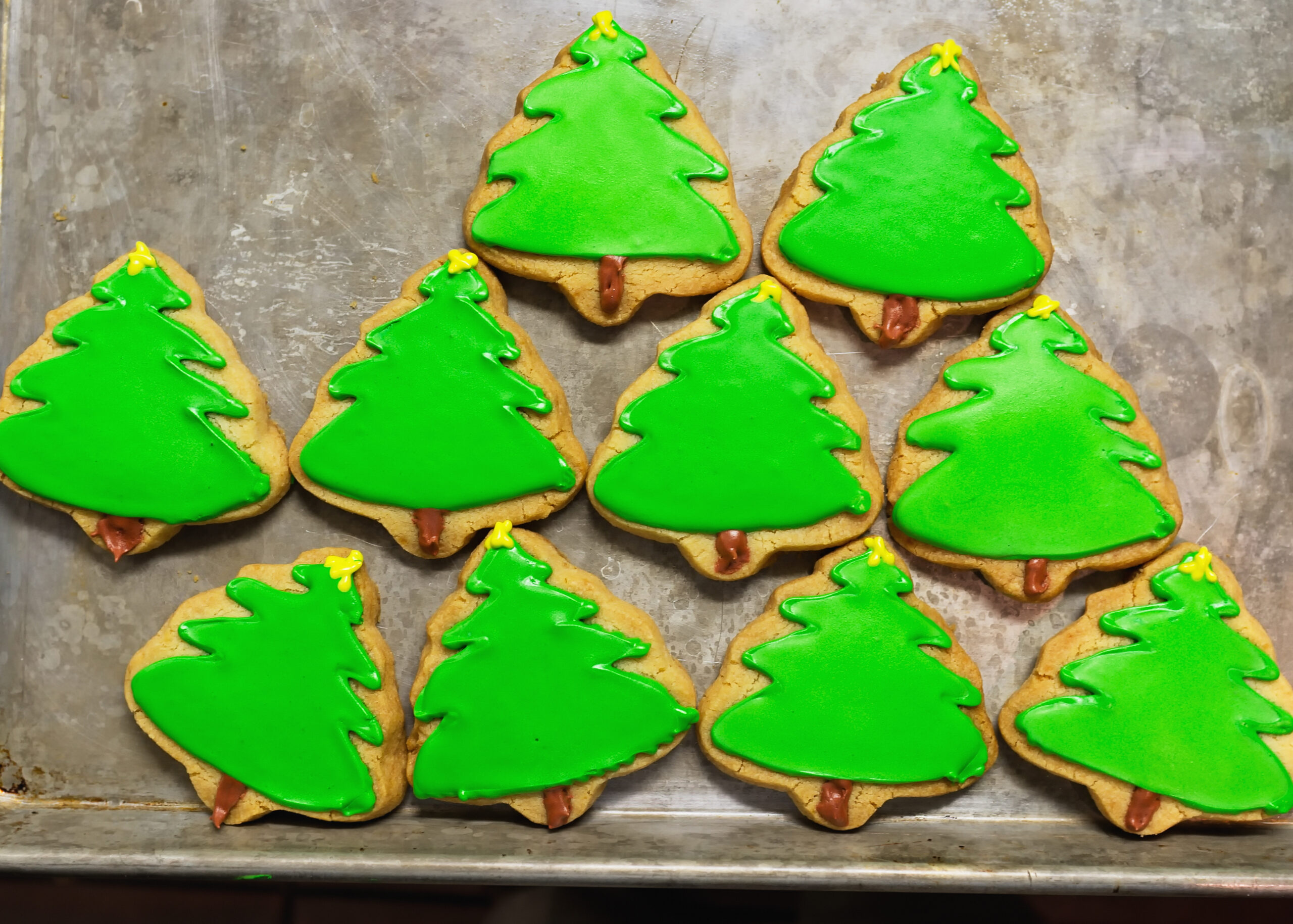 Christmas tree cookies with green icing and sprinkles