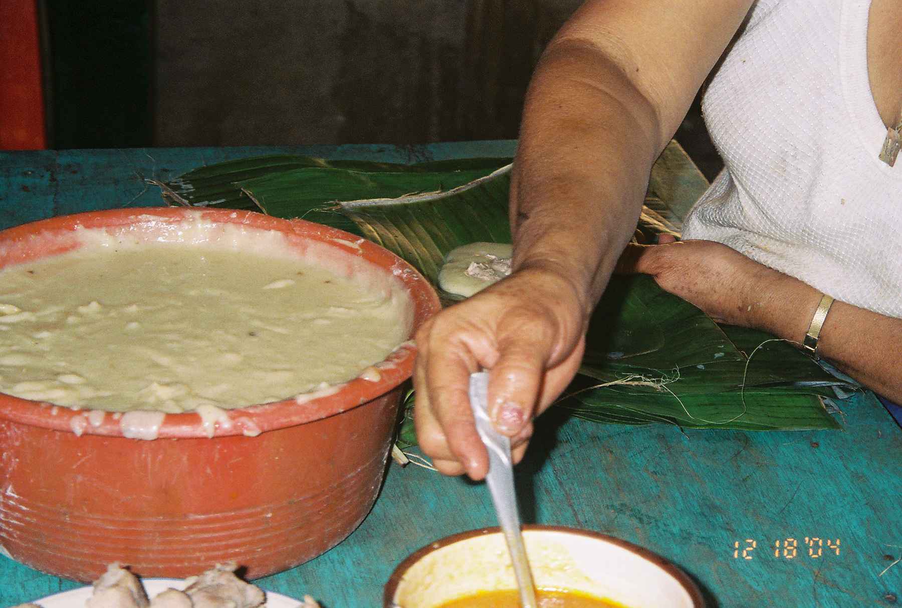 Fresh masa being mixed in a large bowl for homemade Christmas tamales in El Salvador