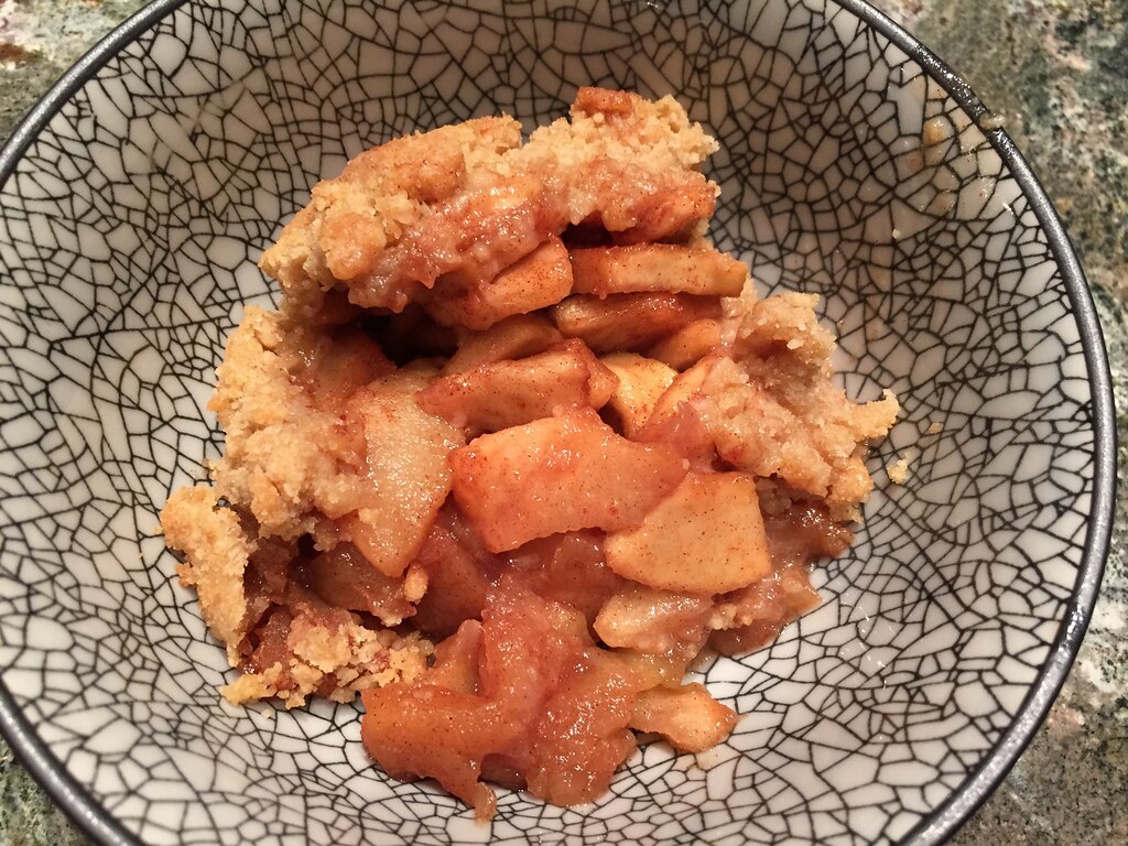 Warm cobbler with golden biscuit pieces in a bowl
