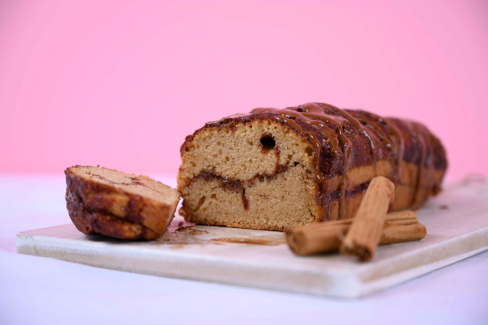 Sliced swirl cake with cinnamon sticks