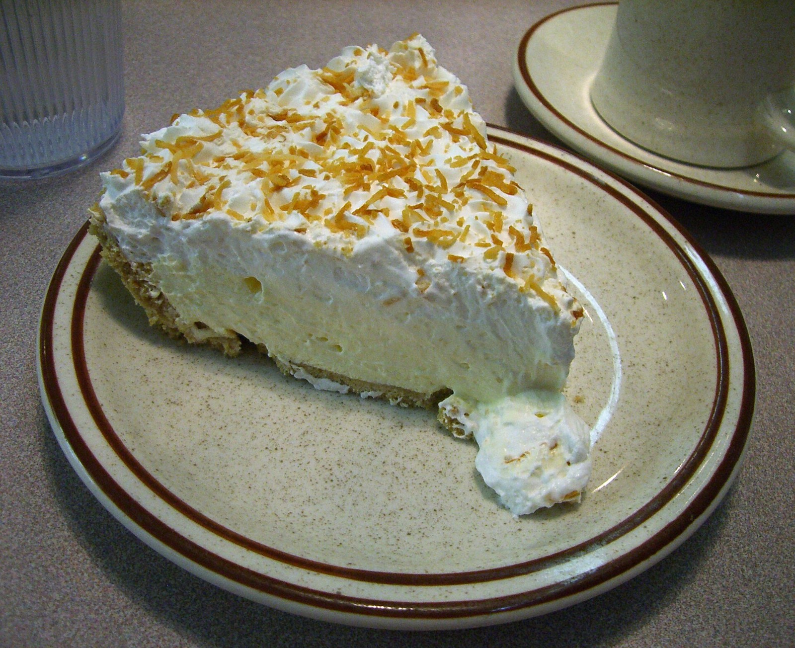 Creamy pie slice with a tall whipped topping
