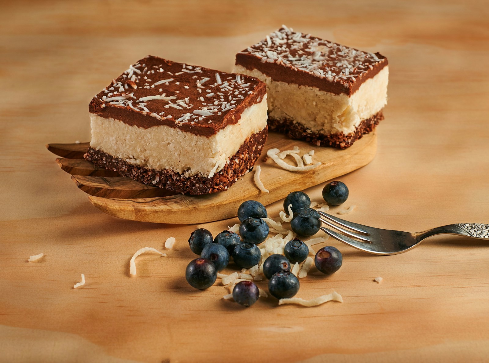 Layered dessert bars with a smooth chocolate top