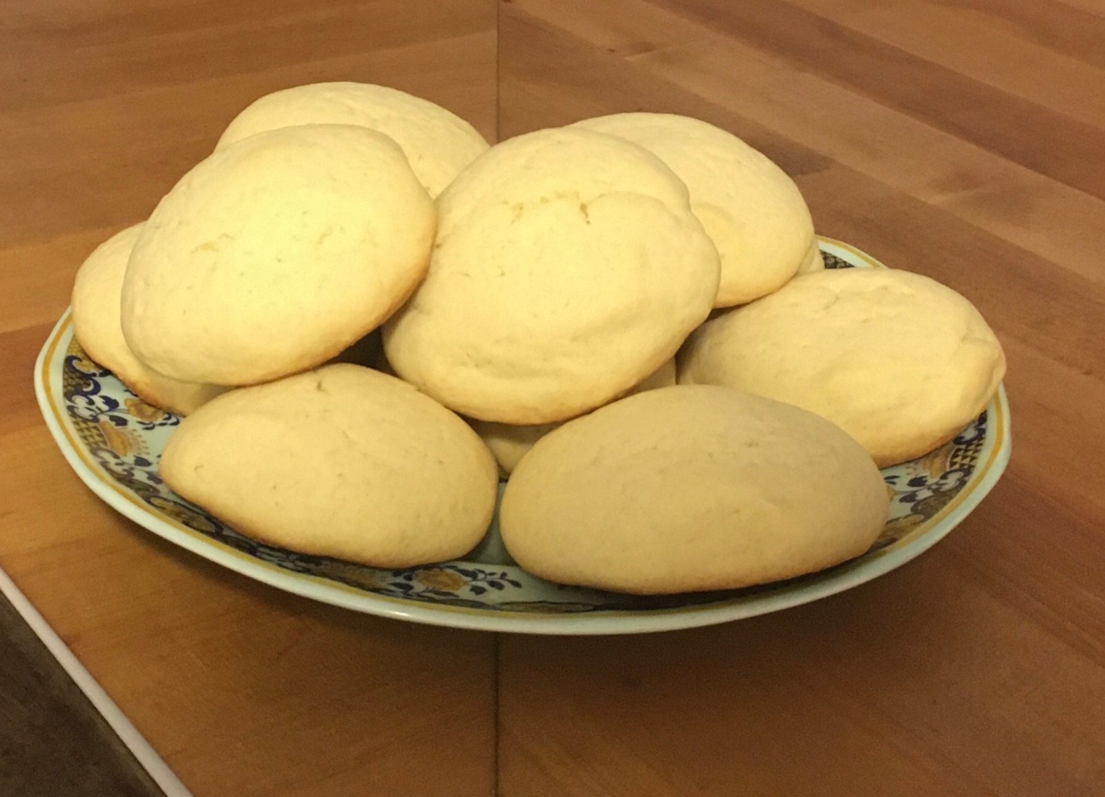 Soft round sugar cookies piled on a plate