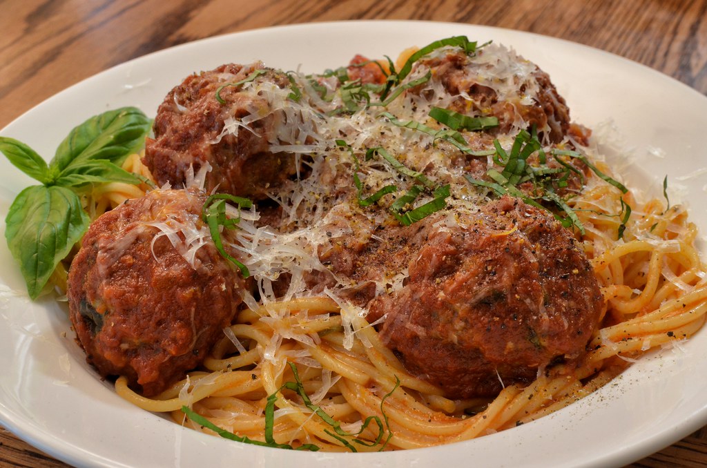 Spaghetti and meatballs in tomato sauce with basil