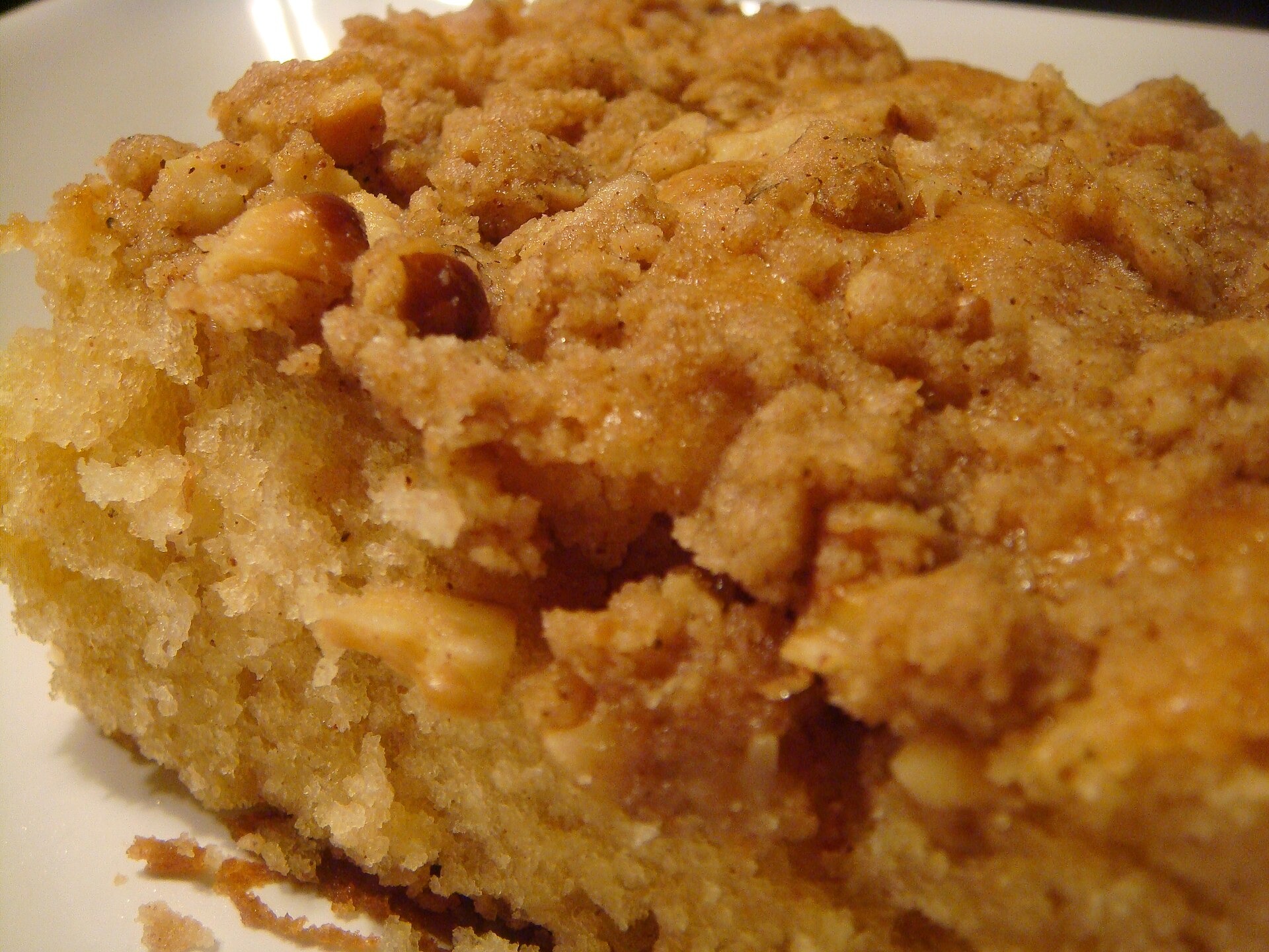 Square of applesauce cake with a crumbly walnut topping, an eggless depression era dessert