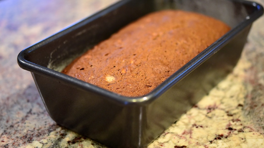 Homemade banana bread loaf, a depression era dessert, in a dark baking pan