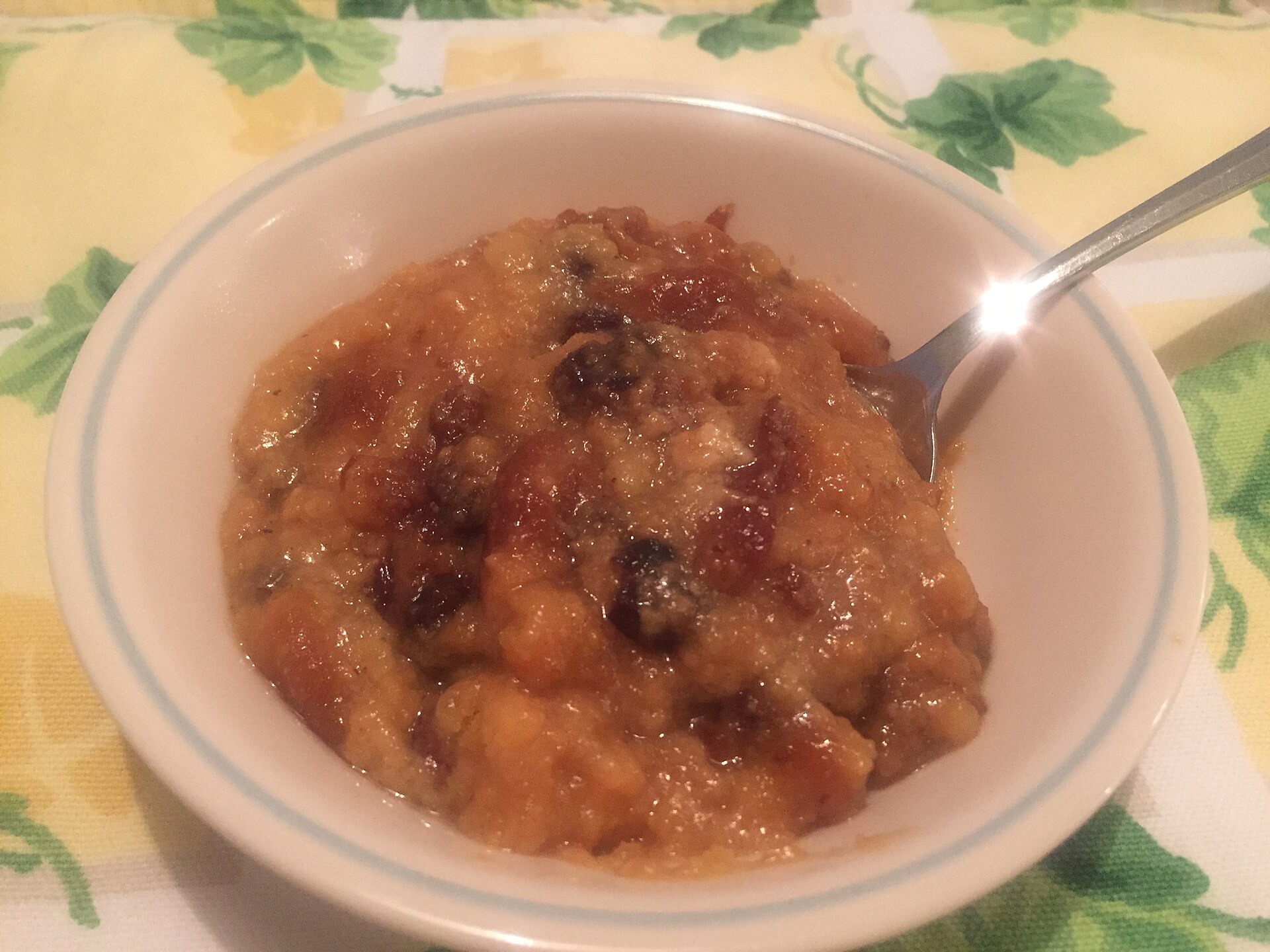 Bowl of warm Indian pudding made with cornmeal and molasses