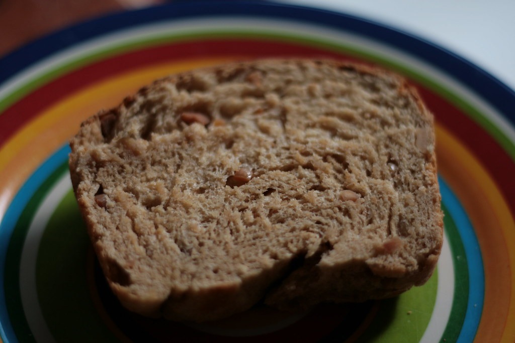 Slice of peanut butter quick bread on a striped plate