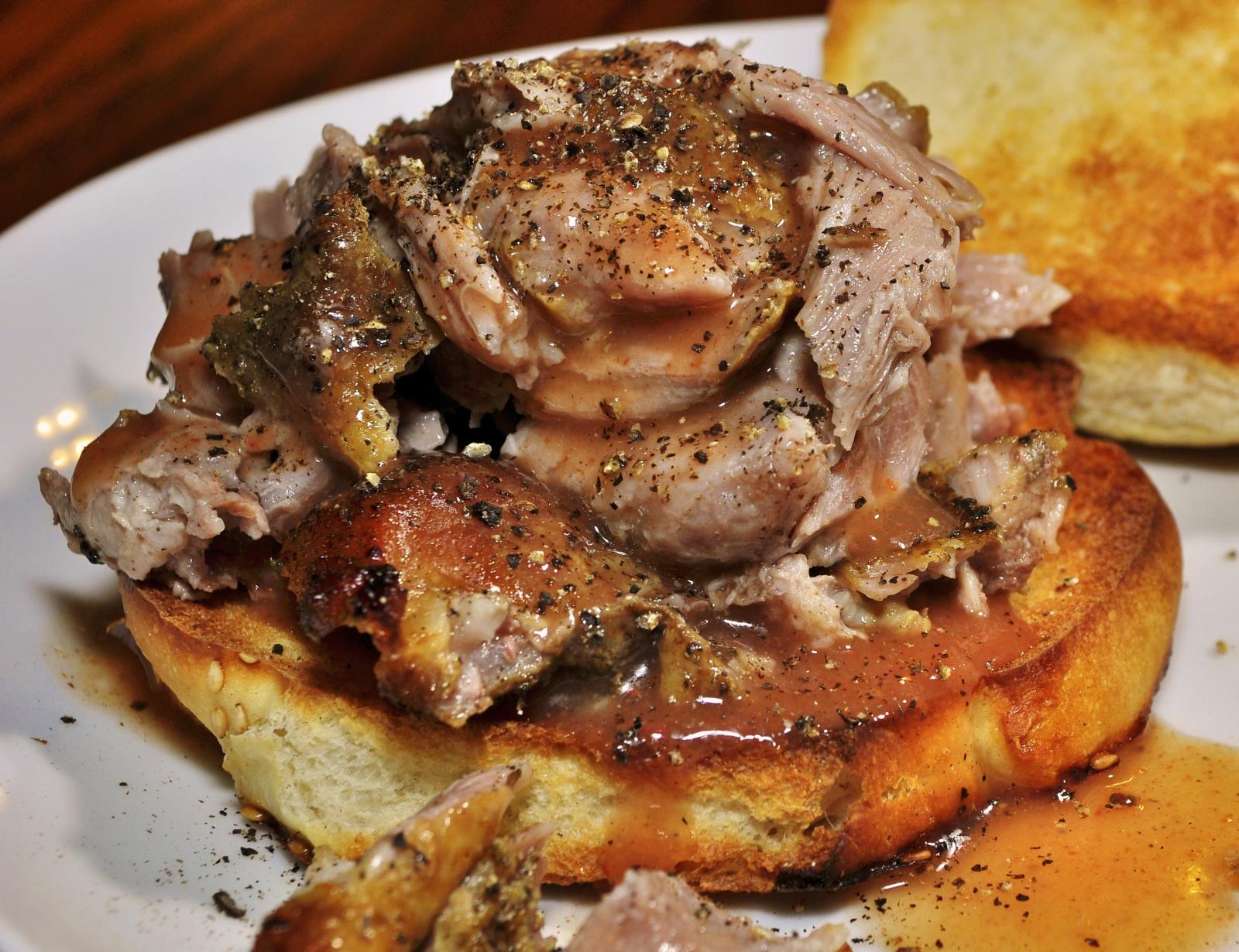 Tender pulled pork with sauce on toasted bread