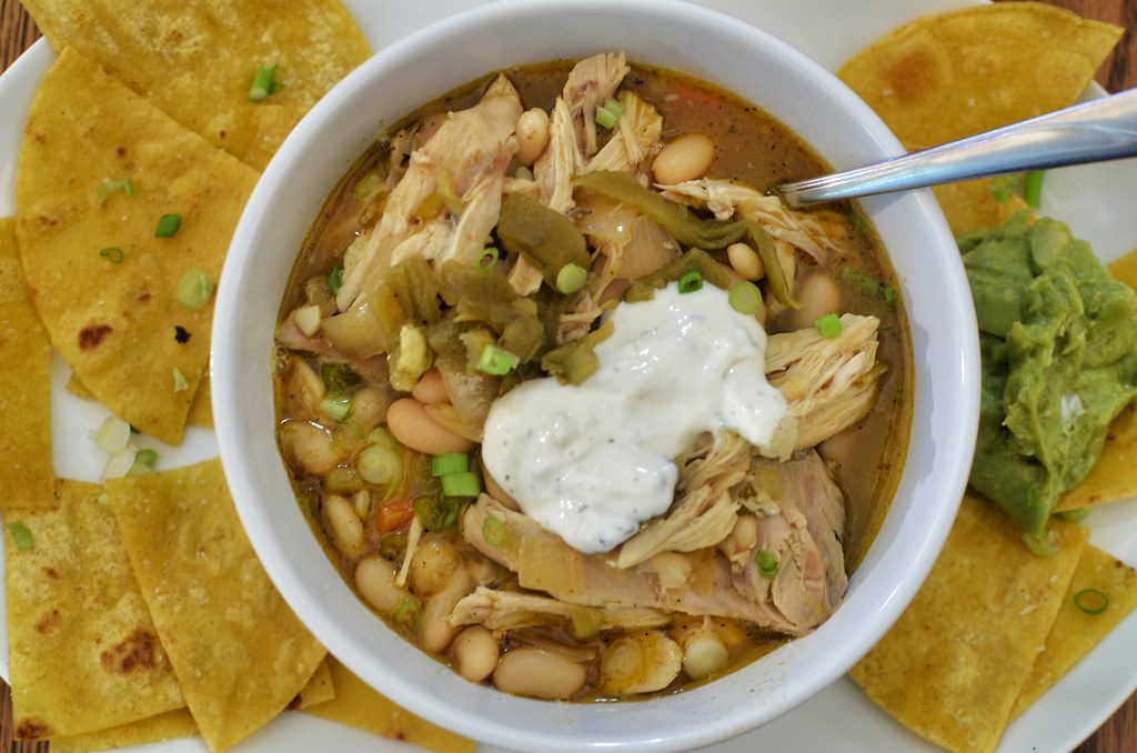 Bowl of creamy white chicken chili with white beans and sour cream