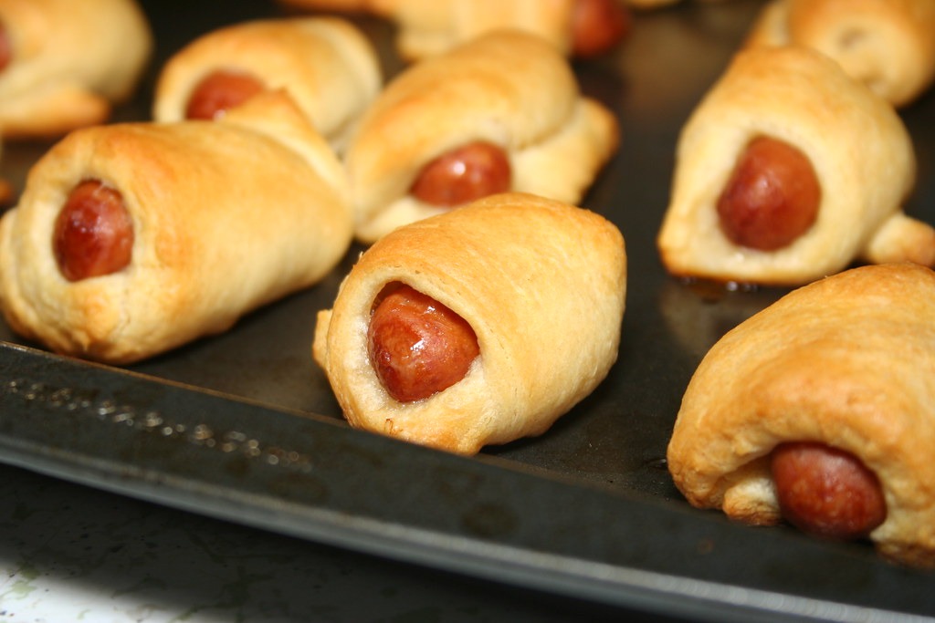 Pigs in a blanket baked golden on a tray