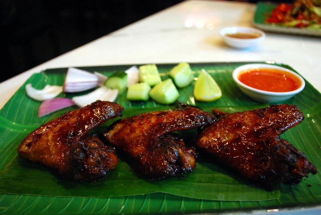 Grilled chicken wings glazed and charred on a platter