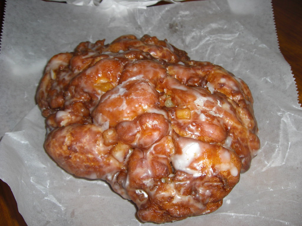 Big glazed fritter on parchment paper
