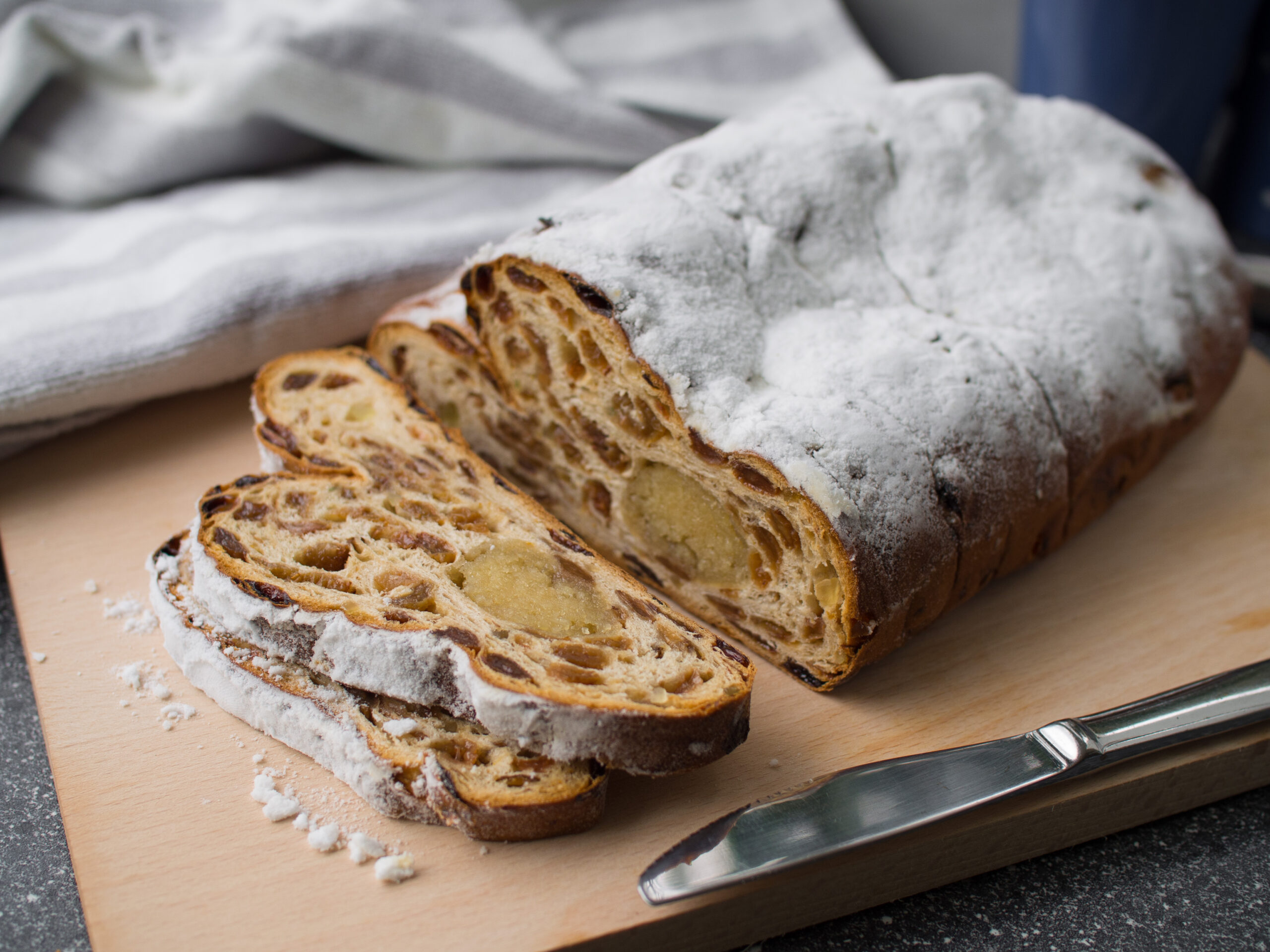 Sliced German stollen dusted with powdered sugar