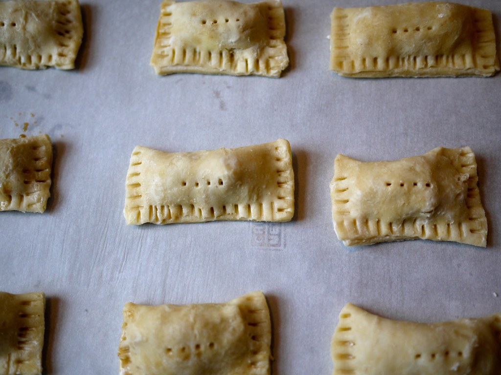 Crimped hand pies on parchment ready for the oven