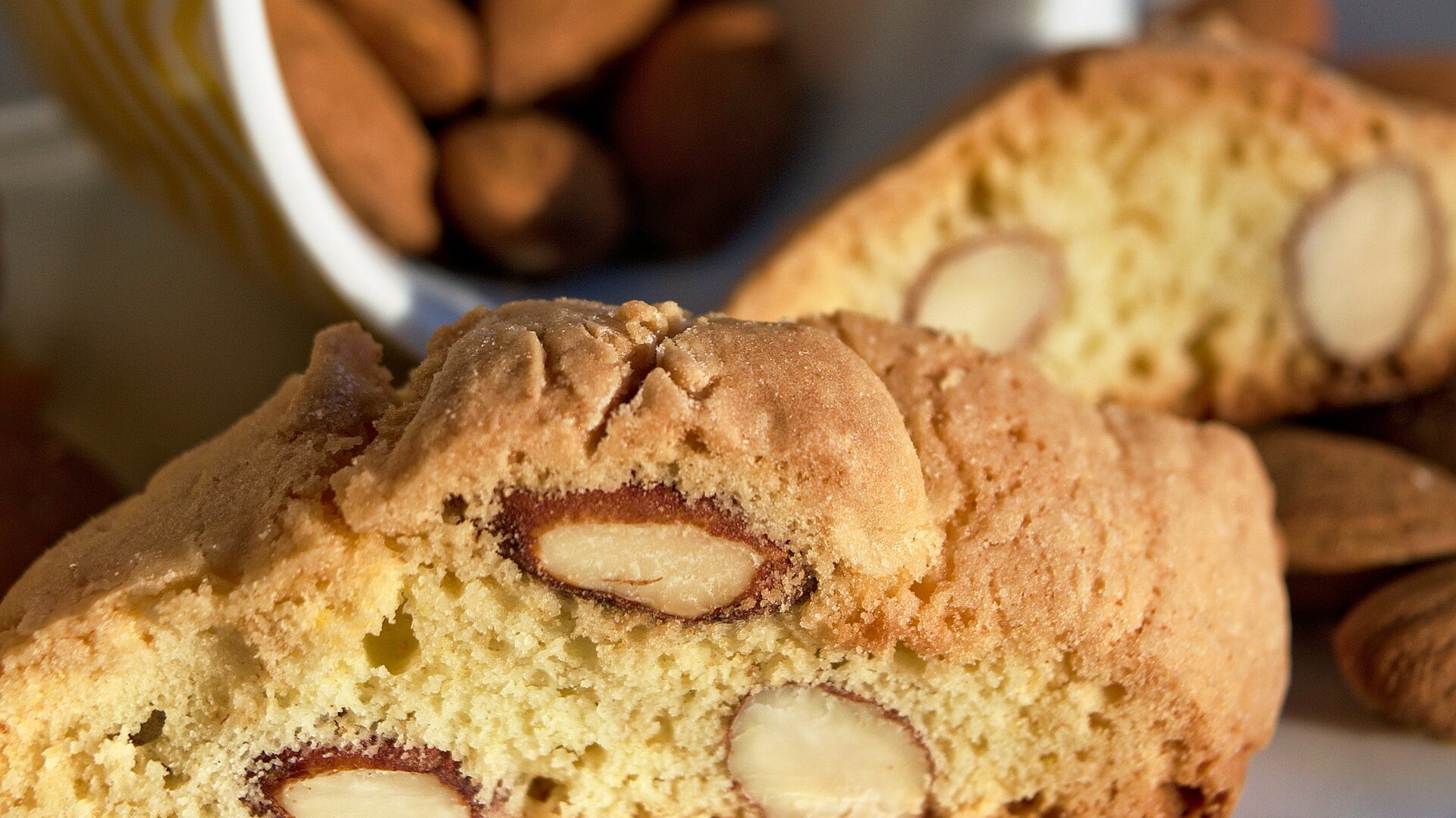 Close view of almond biscotti slices showing whole almonds inside
