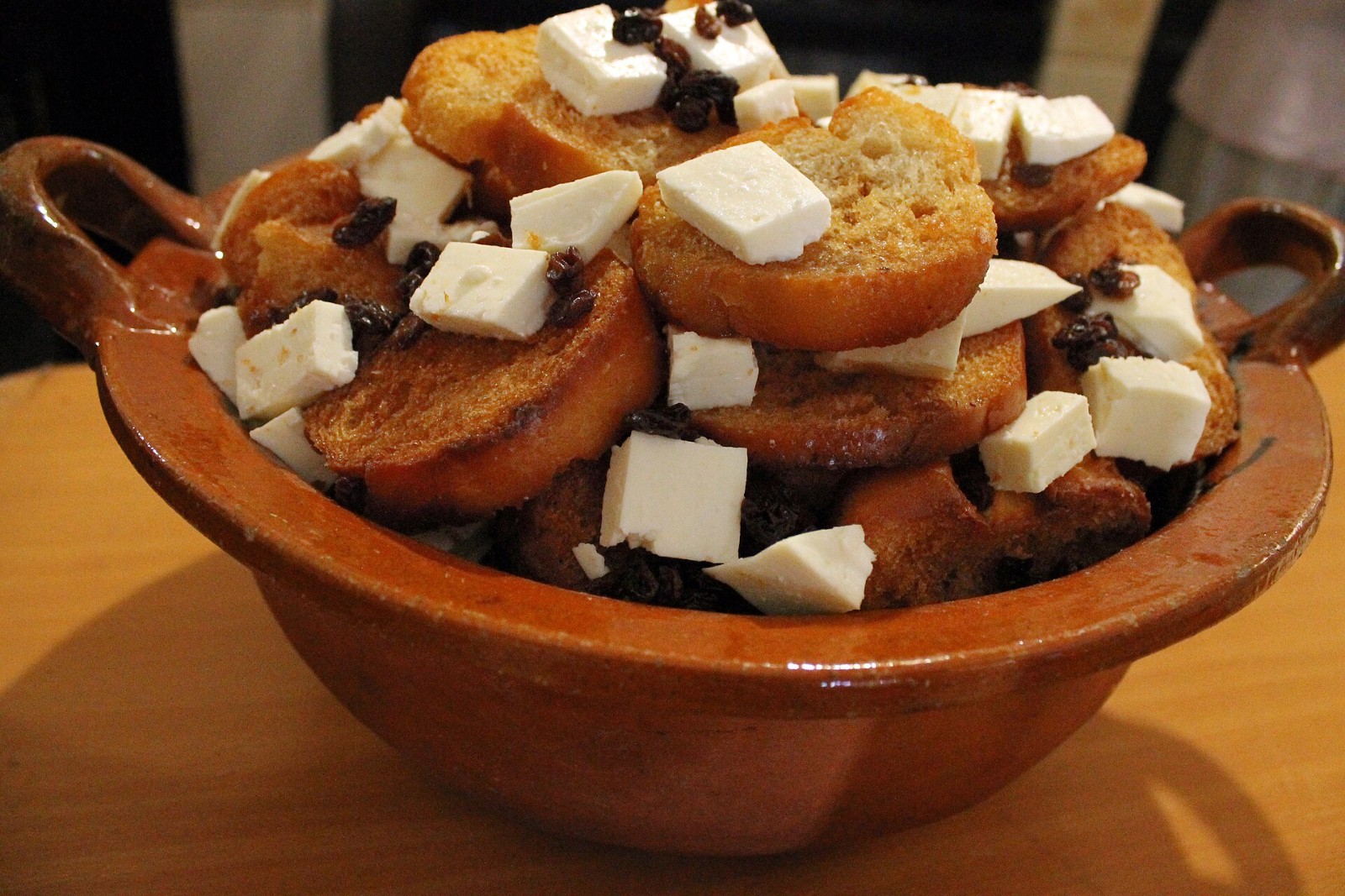 Capirotada Mexican bread pudding in a clay dish