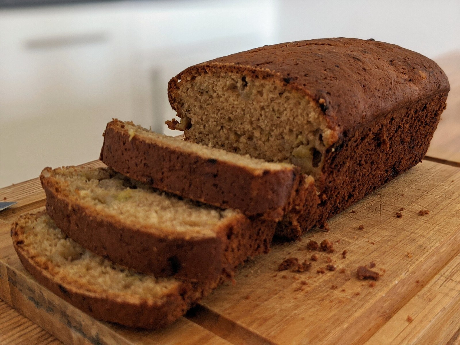 Sliced banana bread loaf on a wooden board