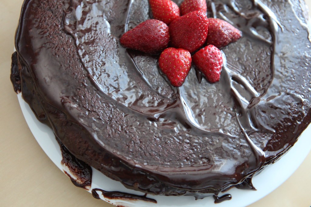 Chocolate fudge cake topped with fresh strawberries