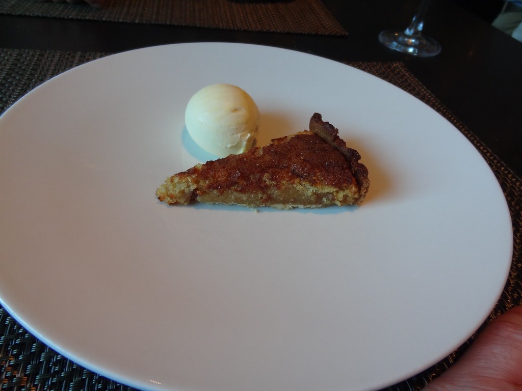 Slice of treacle tart with vanilla ice cream