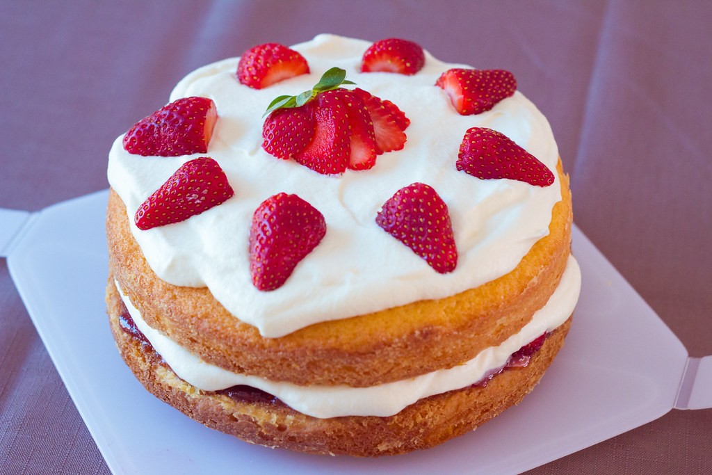 Victoria sponge with jam and strawberries in the style of Nigella Lawson bakes