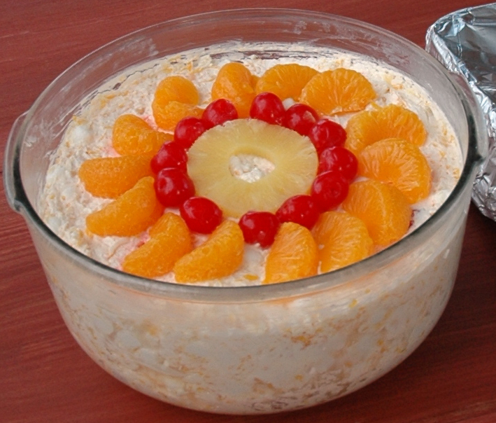 Ambrosia salad topped with mandarin oranges, pineapple and cherries