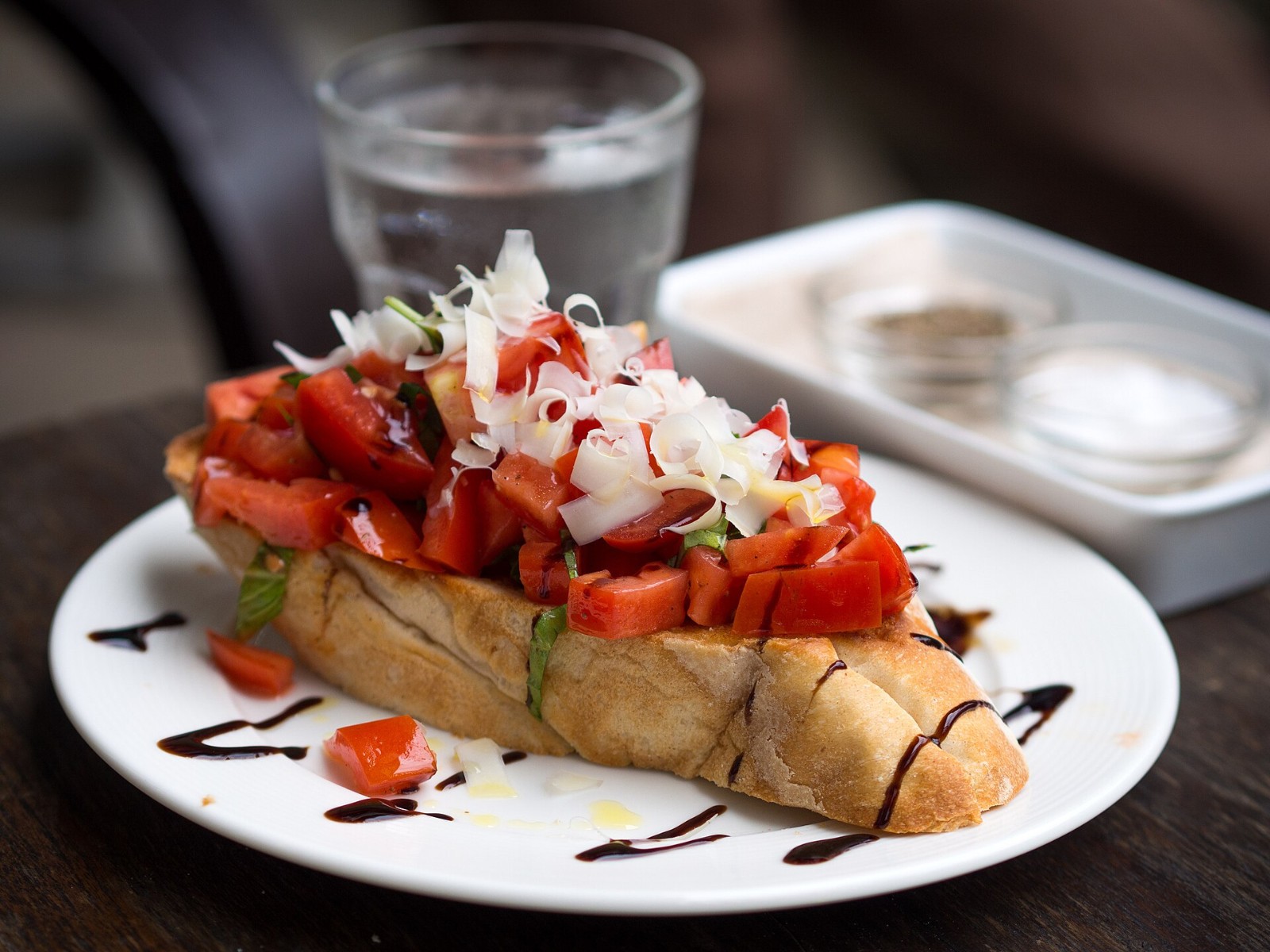 Tomato bruschetta on toasted bread with onion and herbs