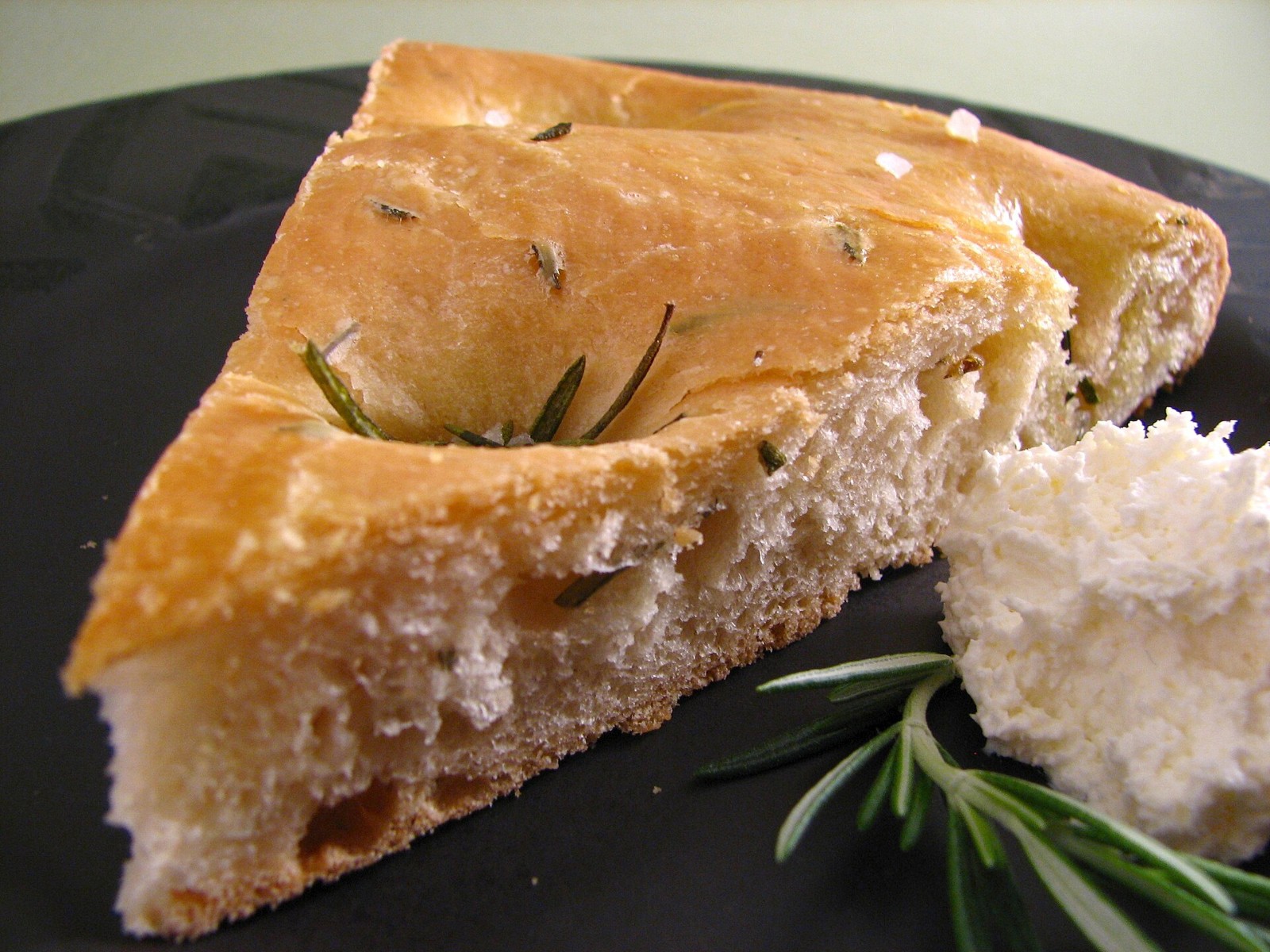 Selena Gomez recipes for bakers: rosemary focaccia slice with fresh rosemary sprigs
