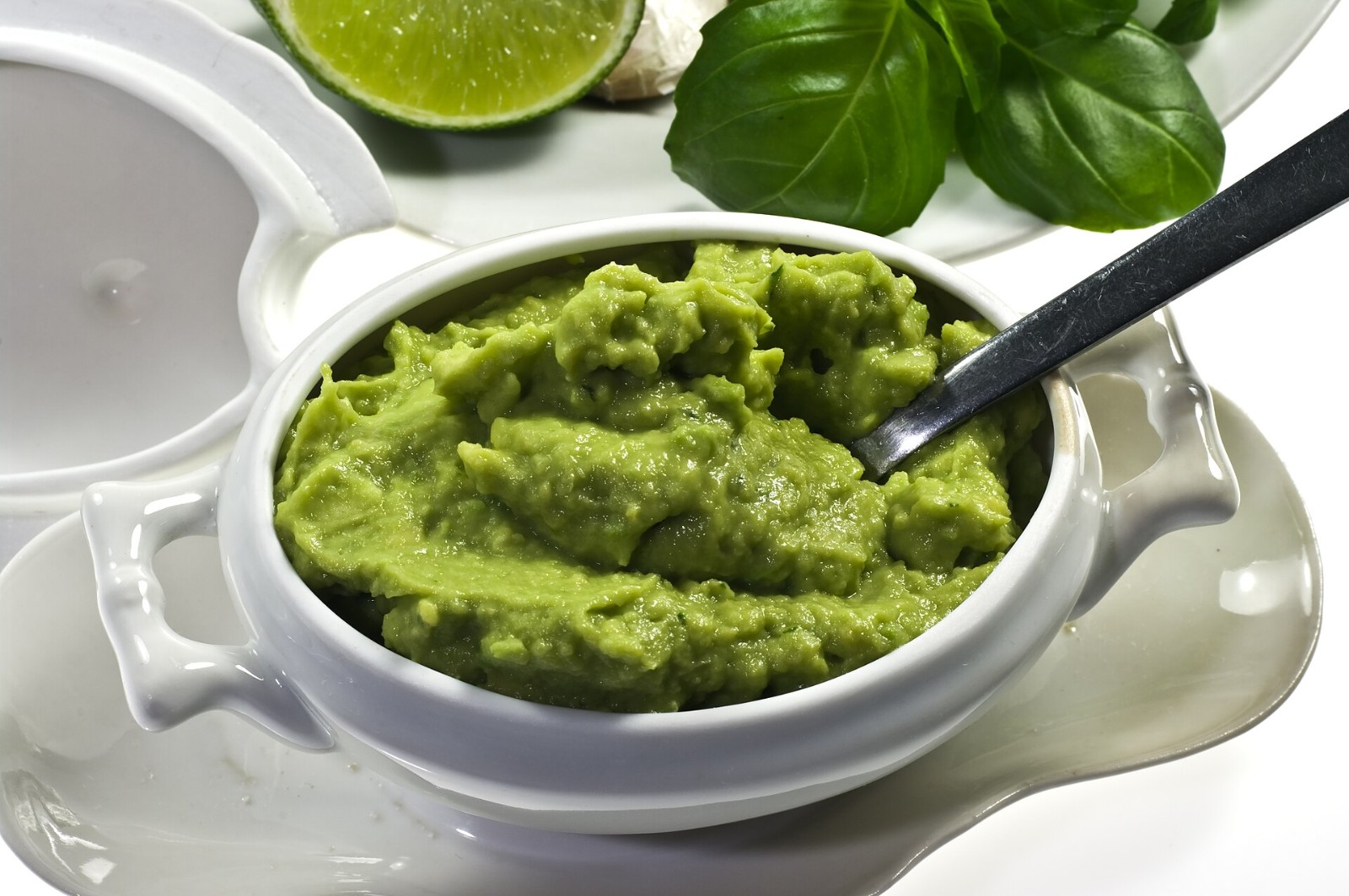 Selena Gomez recipes include fresh chunky guacamole in a white bowl with lime